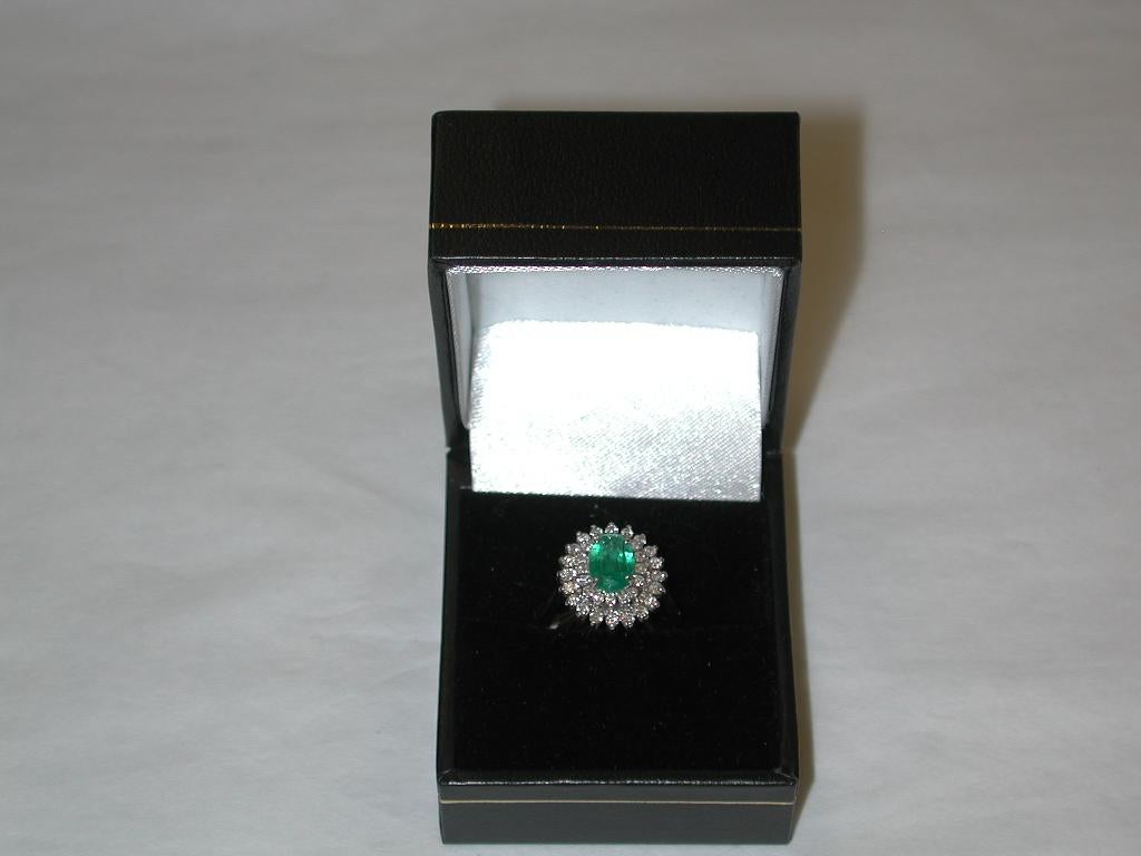 Modern Emerald and Diamond Cluster Ring Mounted in 18 Carat Gold, London, 1979 For Sale