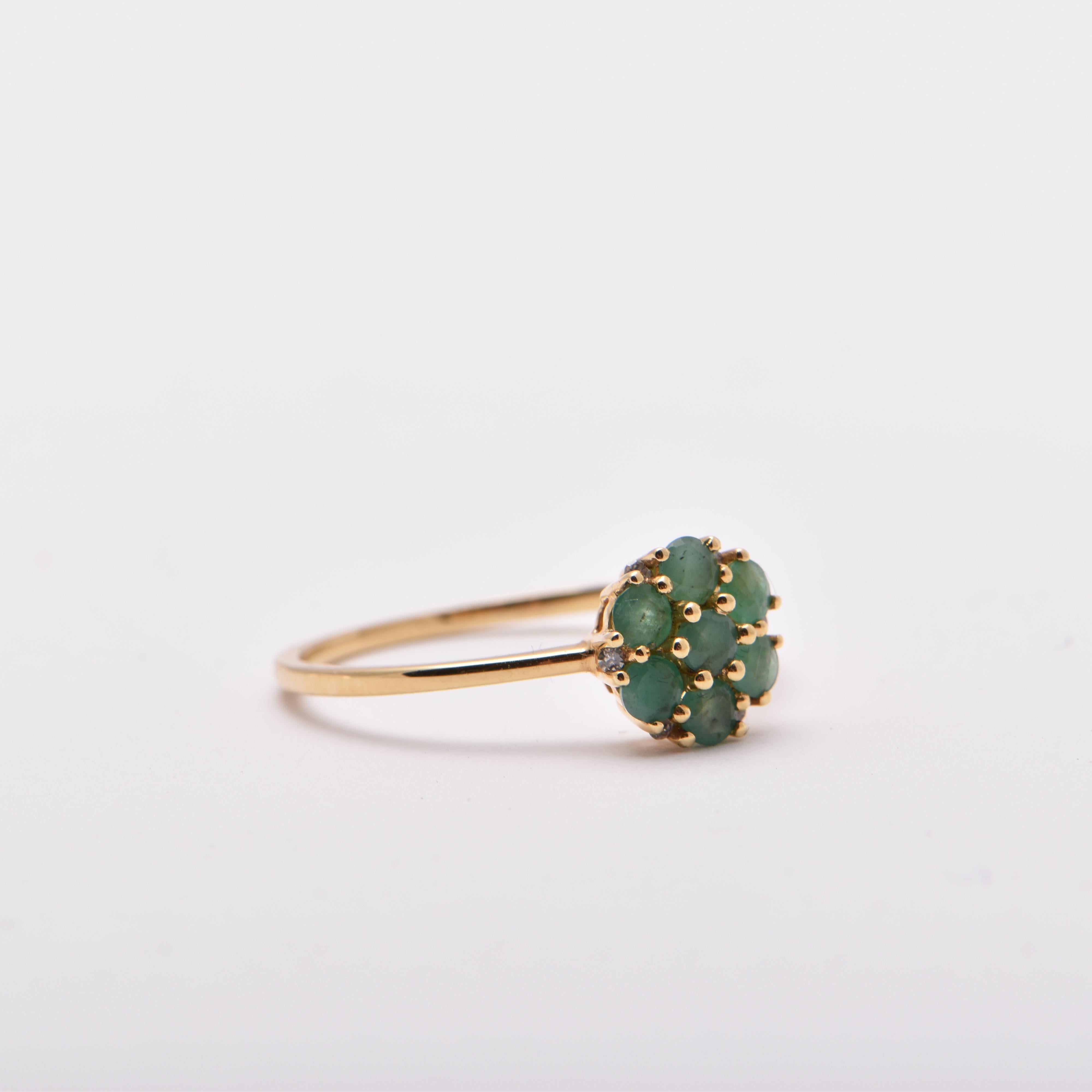 Emerald and Diamond Cluster Style Ring in 18 Carat Yellow Gold by Cartmer Jewellery  

Size N 

7 Emeralds totalling 0.47 Carats  
6 Diamonds totalling 0.04 Carats  
18 Carat Yellow Gold Ring   

FREE express postage usually 3-4 days Sydney to New
