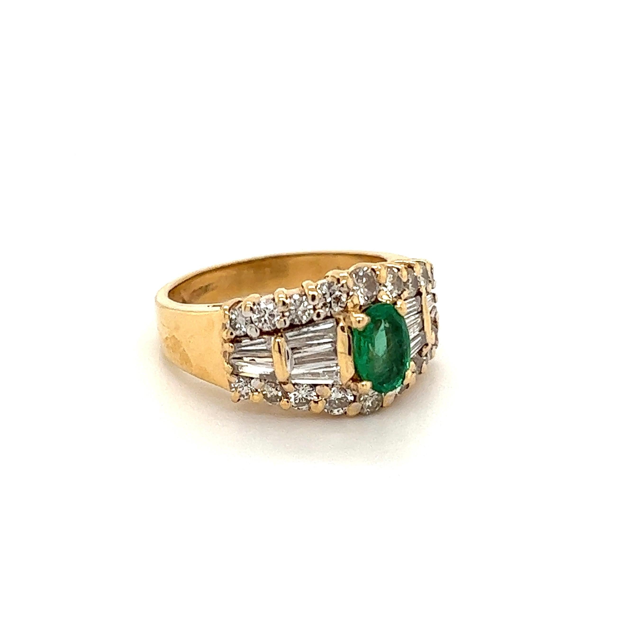 Beautiful and Stylish Emerald and Diamond Gold Band Ring. Securely Hand set with an Oval Emerald, weighing approx. 0.50 Carats and Diamonds weighing approx. 1.00tcw. Hand crafted in 14K White Gold. Measuring approx. 0.92” w x 0.73” w x 0.40” h. Ring