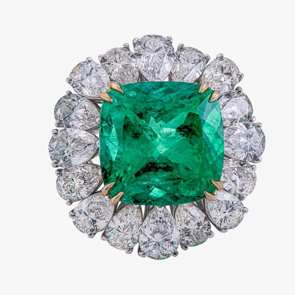 18 karat white and yellow gold Emerald and Diamond cocktail ring from Laviere's Viridian Collection. The ring is set with an impressive 16.77 carat emerald and surrounded by 12.75 carats of brilliant-cut and pear shape diamonds.

Gross Weight of the