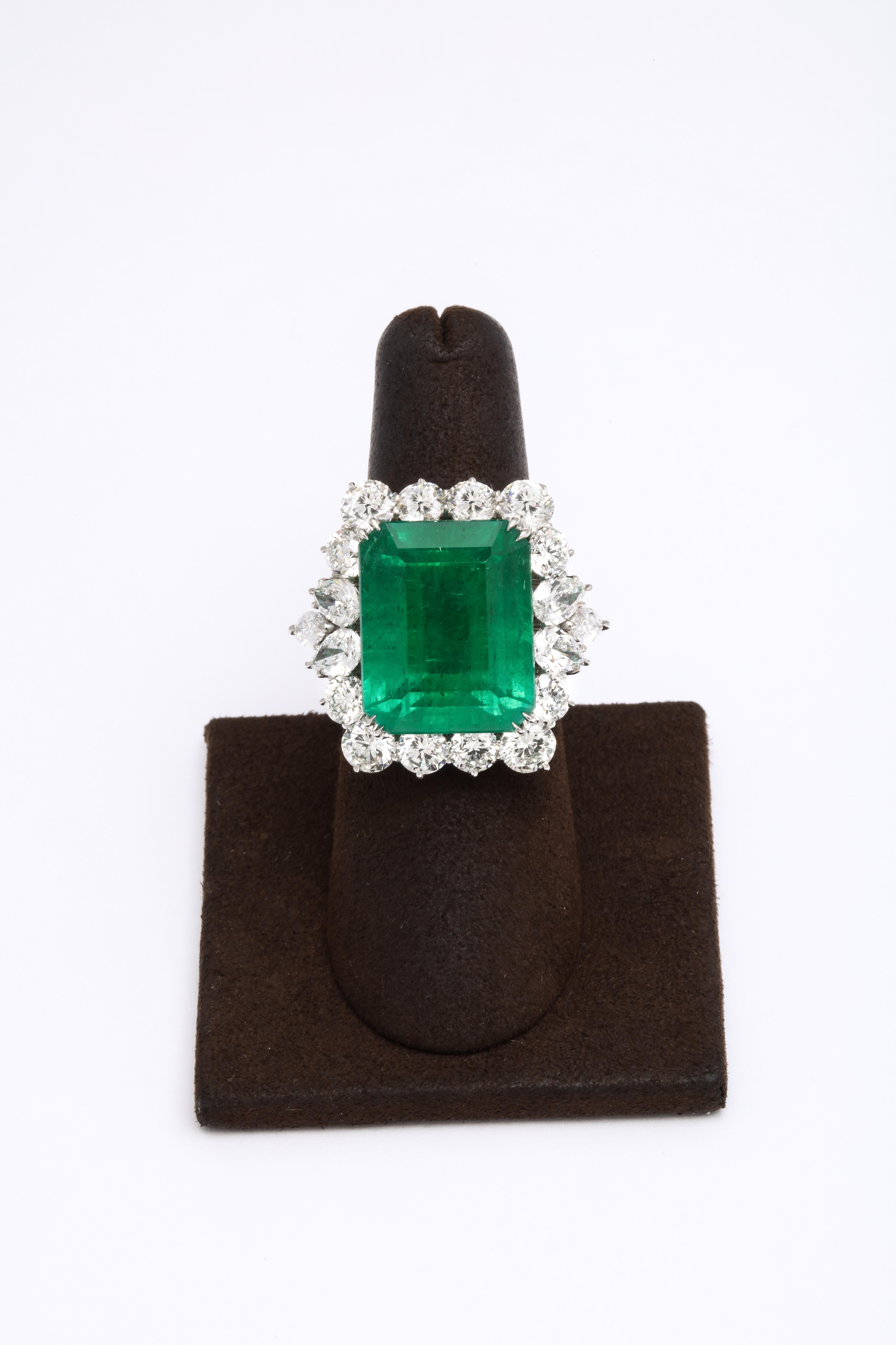 
A beautiful statement ring!

Featuring a fine 19.43 carat emerald surrounded by 6.13 carats of white round, pear and marquise shaped diamonds.

Set in a custom platinum mounting. 

Size 6.25, this ring can easily be resized.

Approximately .75