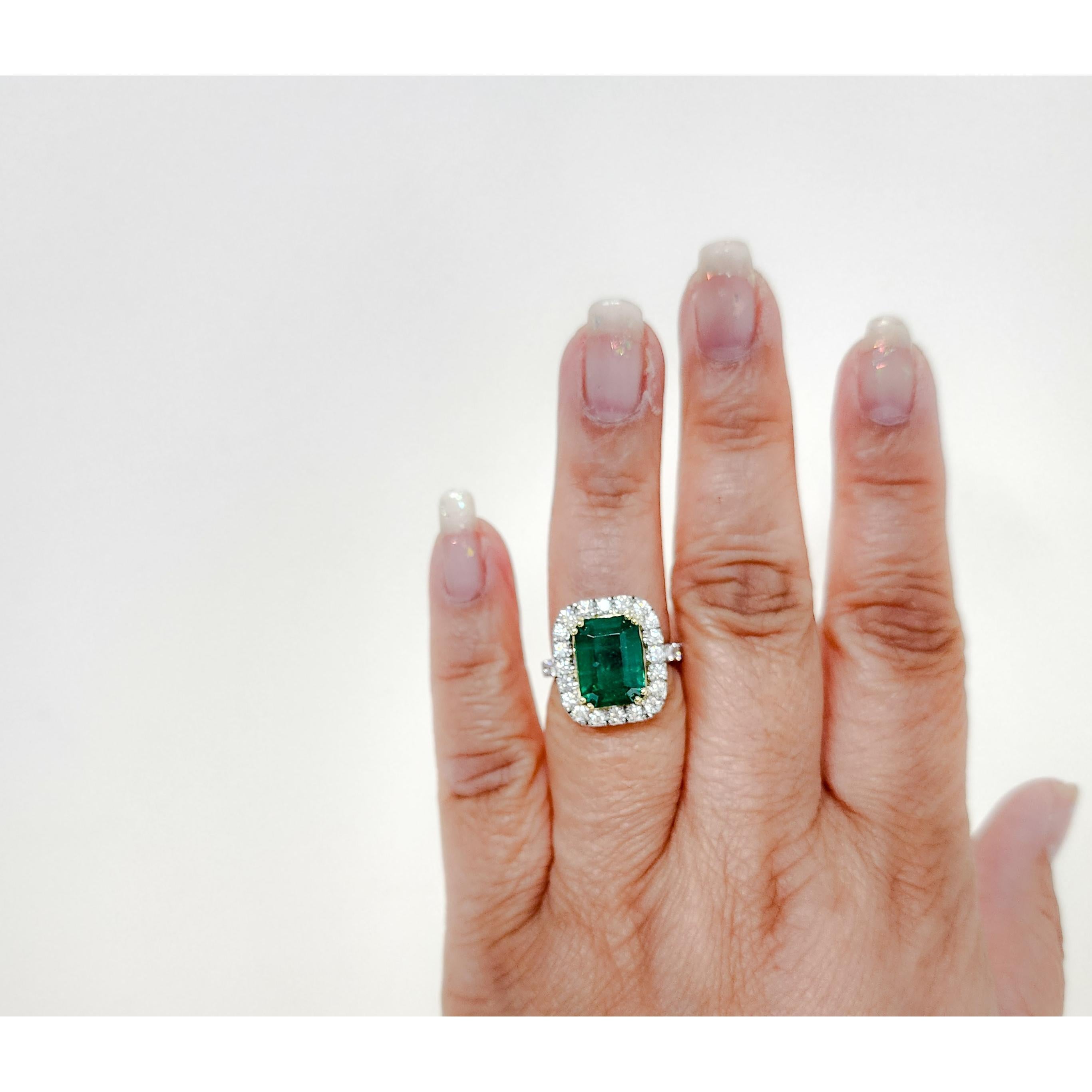 Beautiful 5.80 ct. emerald emerald cut with good quality white diamond rounds around the emerald and on the band.  Handmade in 18k yellow gold and platinum.  Ring size 6.75.