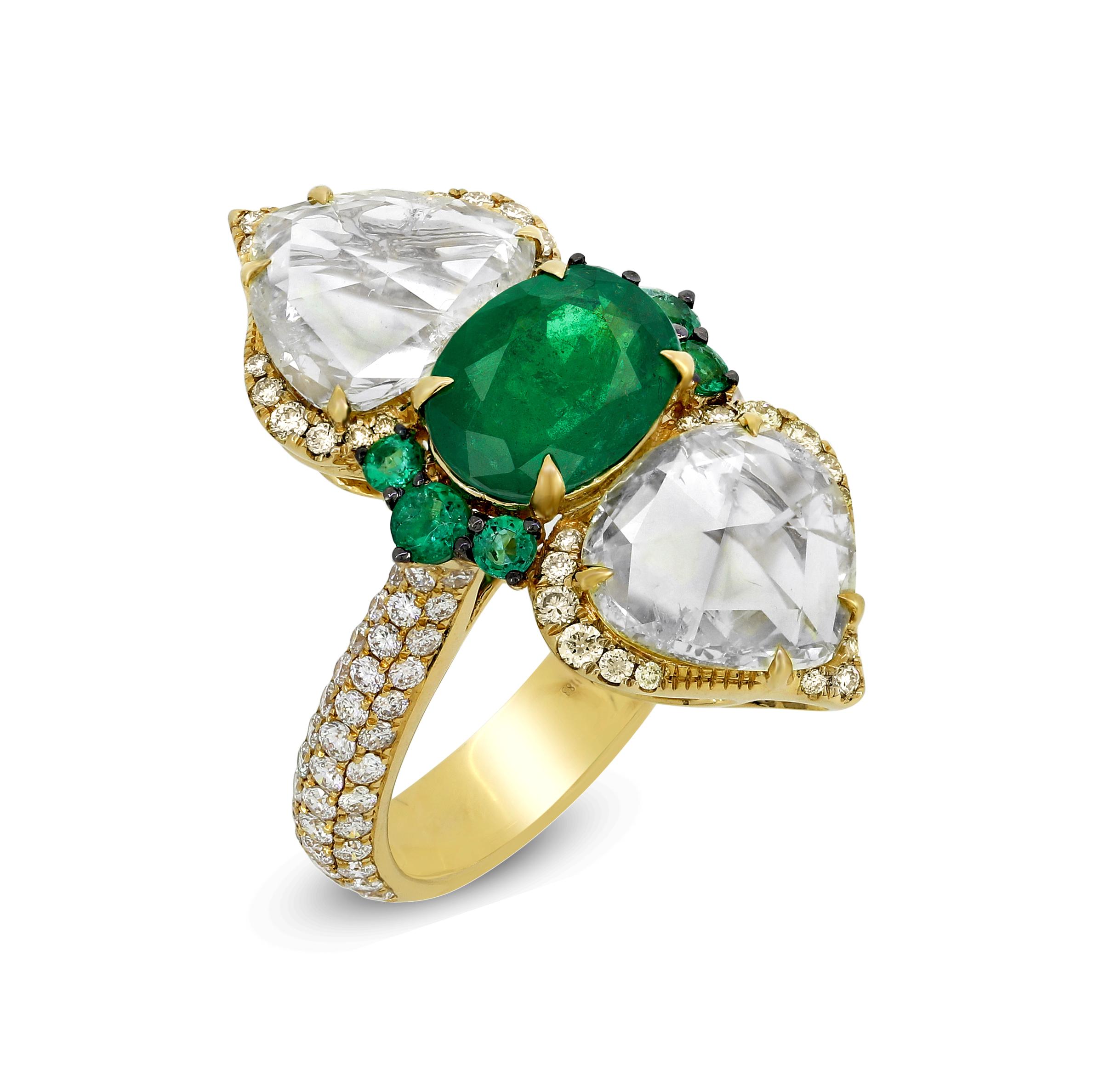 If you are look for unconventional charm in your jewelry then this exclusive Emerald and rose cut diamond 18k Yellow Gold ring has to be a part of your collection. Paired with two large rose cut diamonds on each side, this versatile ring can be worn