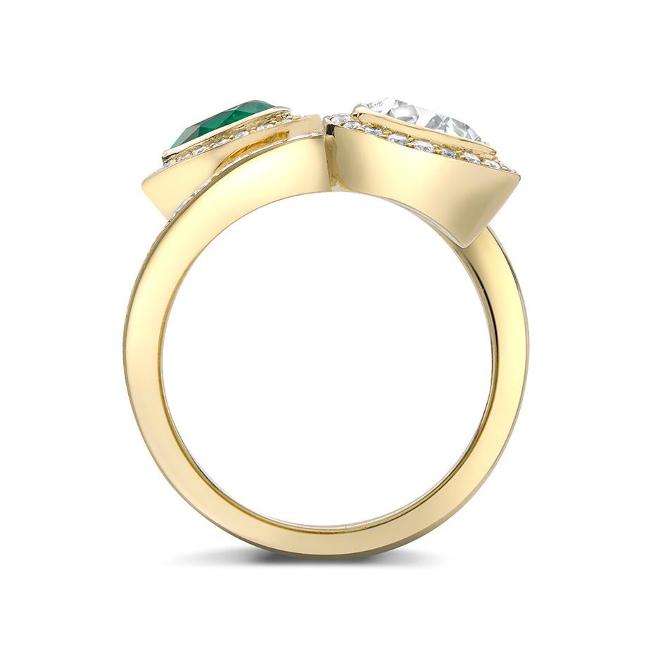A fabulous pear shape Colombian emerald and diamond crossover ring mounted in 18ct yellow gold with grain set diamond shank.  The emerald is a rich vibrant green and very clean with the pear shape diamond 0.50ct EVS2 (GIA certificate)