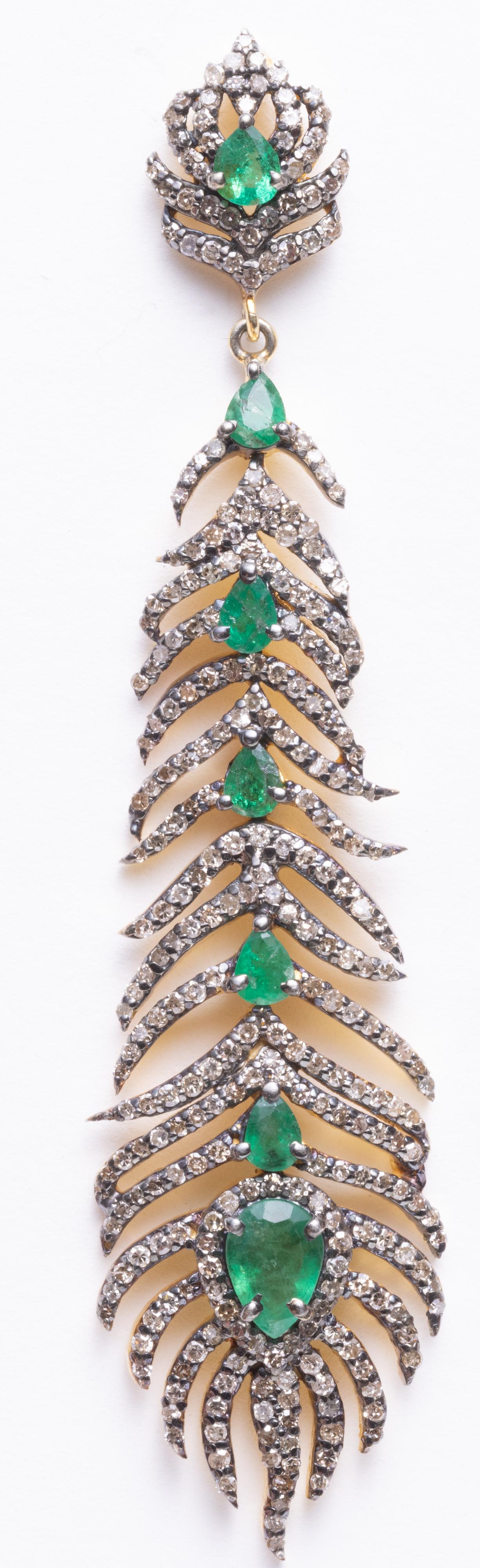 A graduated pair of dangle chandelier earrings.  Cascading, pear-shaped and faceted emeralds bordered with round, brilliant cut diamonds in a pave` setting.  Set in sterling silver with 18K gold post.  Diamonds total 3.24 carats, emeralds total