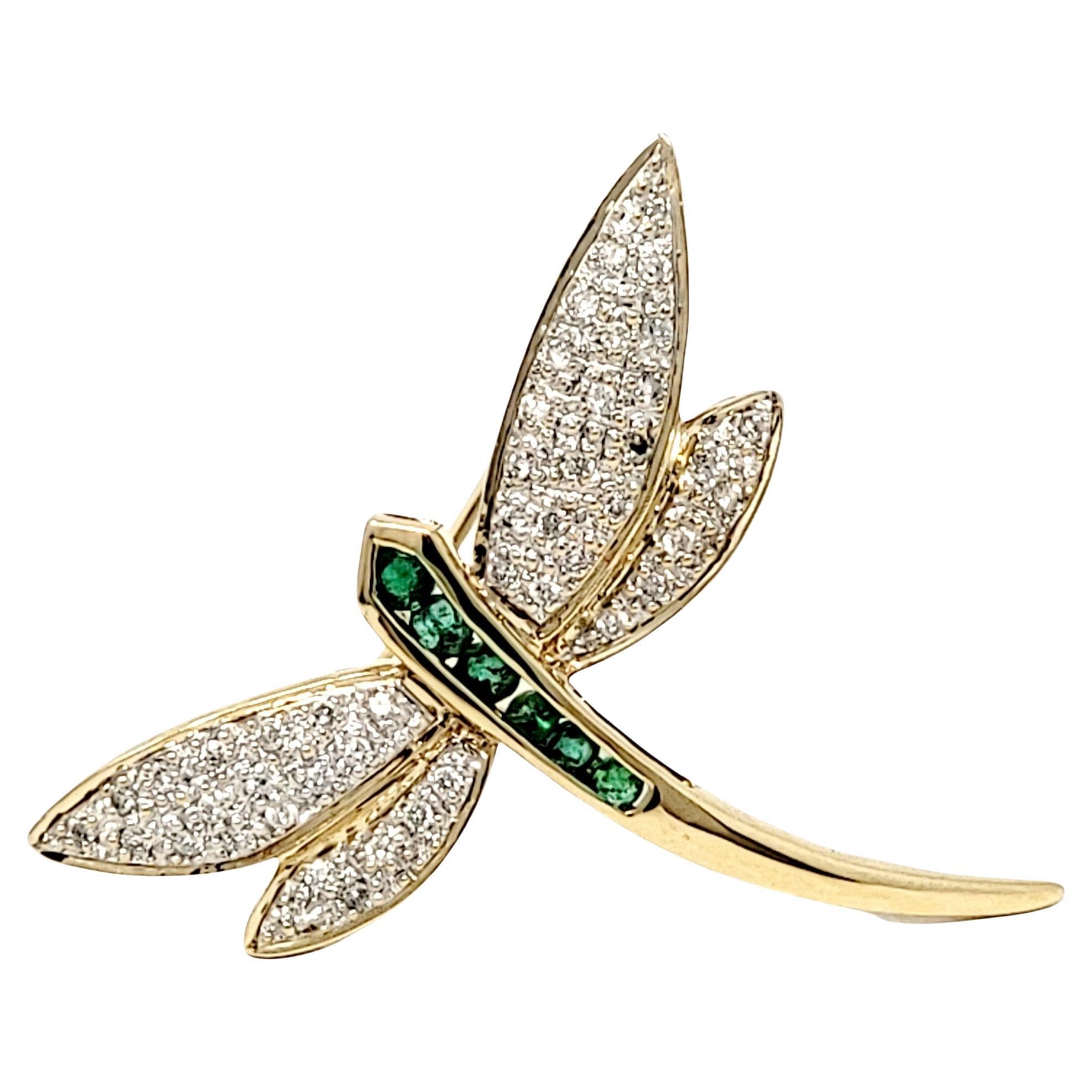 Beautifully detailed dragonfly brooch accented with glittering white diamonds and bright green emeralds. Simple yet stunning piece gives the perfect touch of sparkle to enhance your look. 

Type: Brooch
Metal: 14K Yellow Gold 
Natural Diamonds: .45