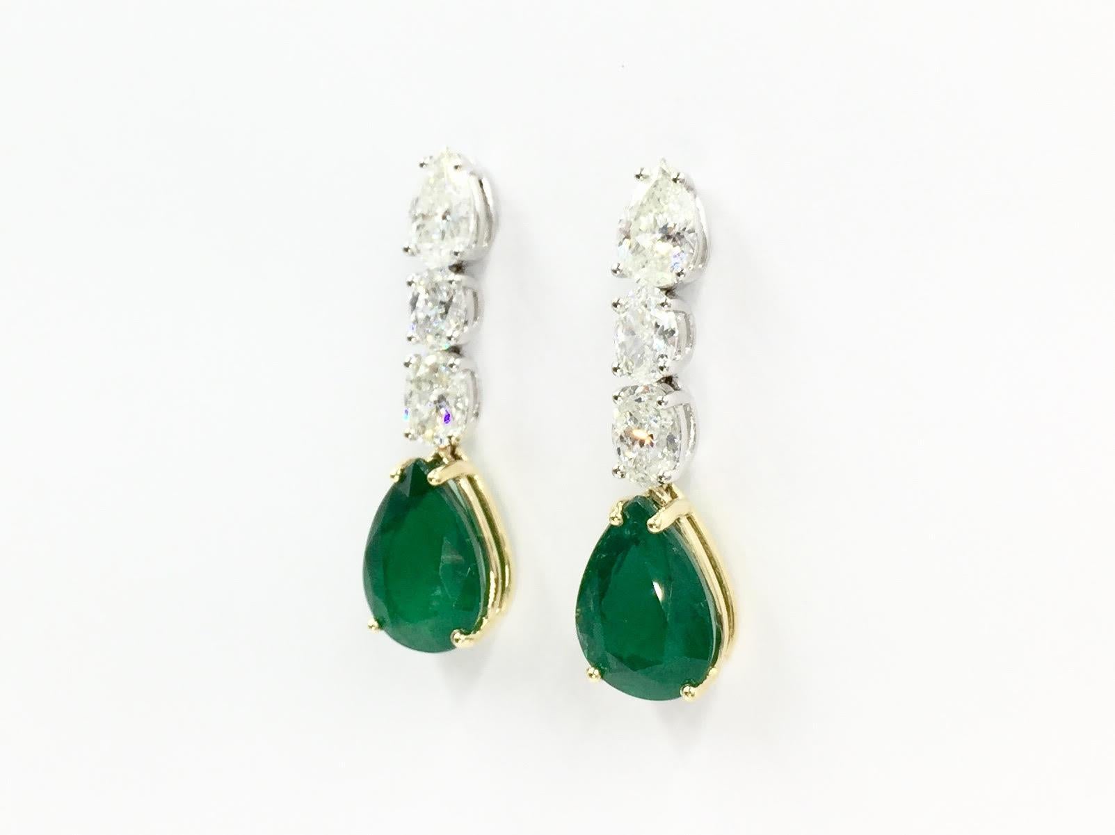A stunning pair with gorgeous quality emeralds! The earrings have a total weight of 8.48 carats of pear shape emeralds that hang beautifully from three diamonds. Total weight of pear shape and oval brilliant diamonds is 3.43 carats, approximately