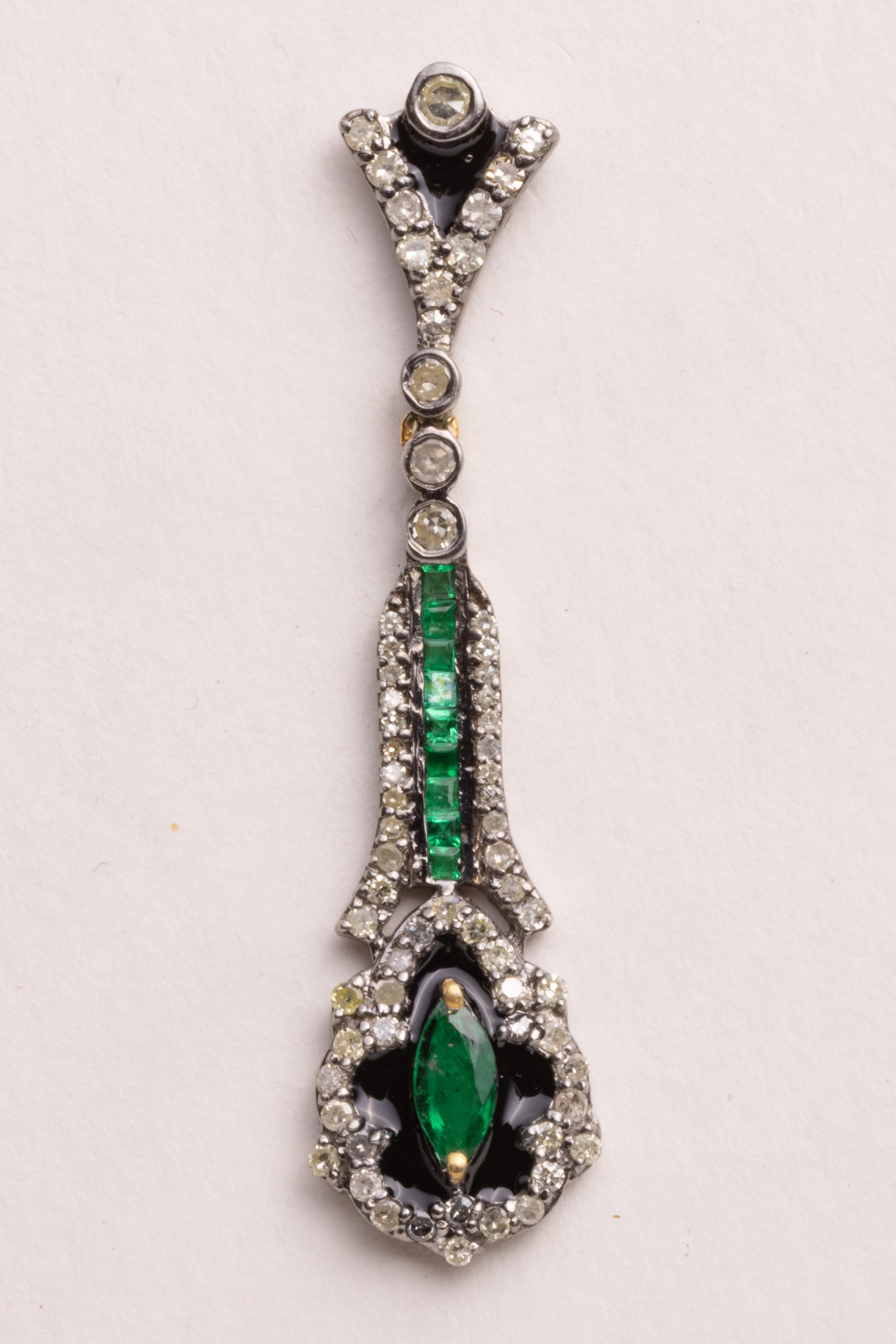 A pair of lovely diamond and emerald dangle drop earrings. 
The emeralds feature a line of channel set emeralds and a marquise emerald at the bottom.  The diamonds are round, brilliant diamonds.  Post is 18K for pierced ears.  Diamonds total 1.12