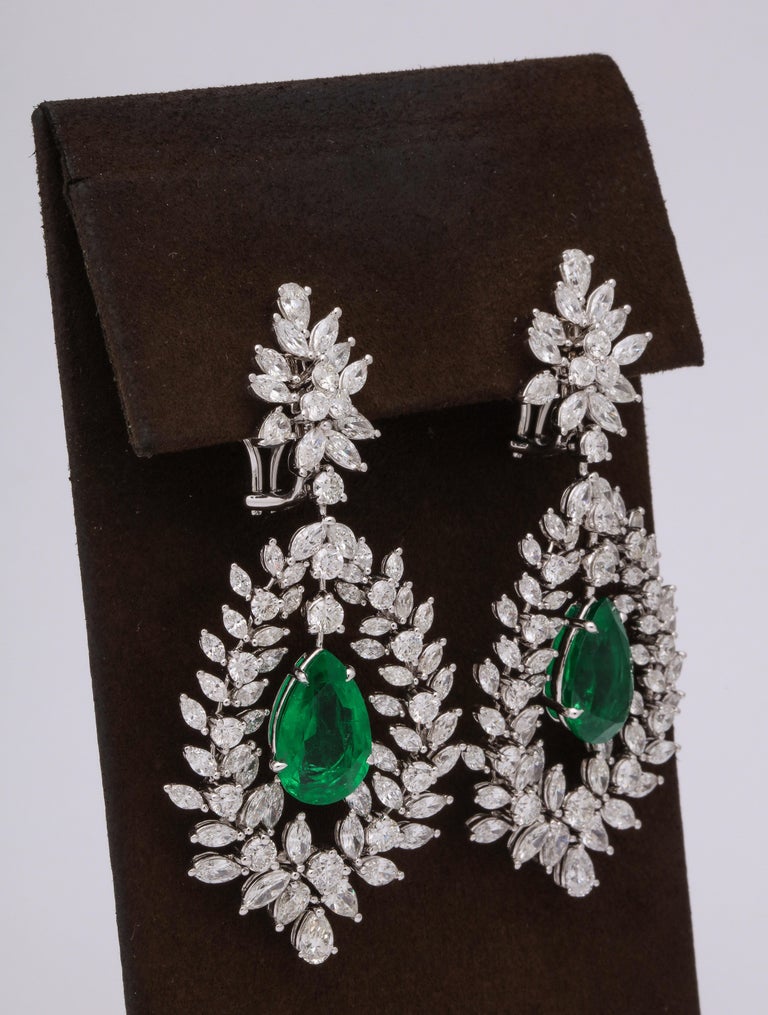 
A grand pair of Emerald and Diamond Dangle Earrings 

11.67 carats of certified VIVID GREEN emeralds. 

16.30 carats of white diamonds, all set in 18k white gold. 

Approximately 6.5 cm long and 3 cm wide. 

Certified by Christian Dunaigre of