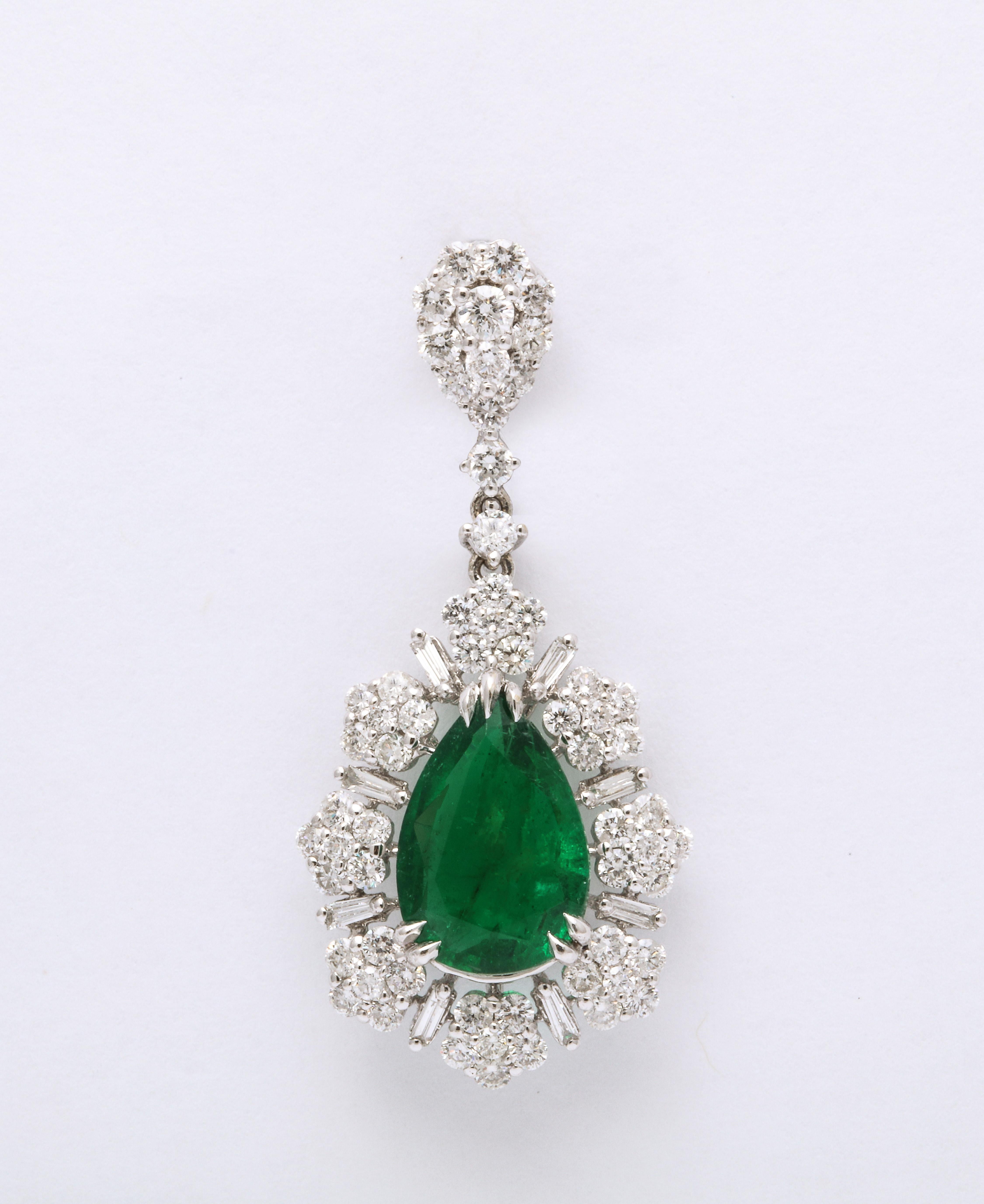 
3.81 carats of Fine Green Emerald

2.84 carats of white round brilliant and baguette cut diamonds. 

18k white gold 

1.4 inches long. 