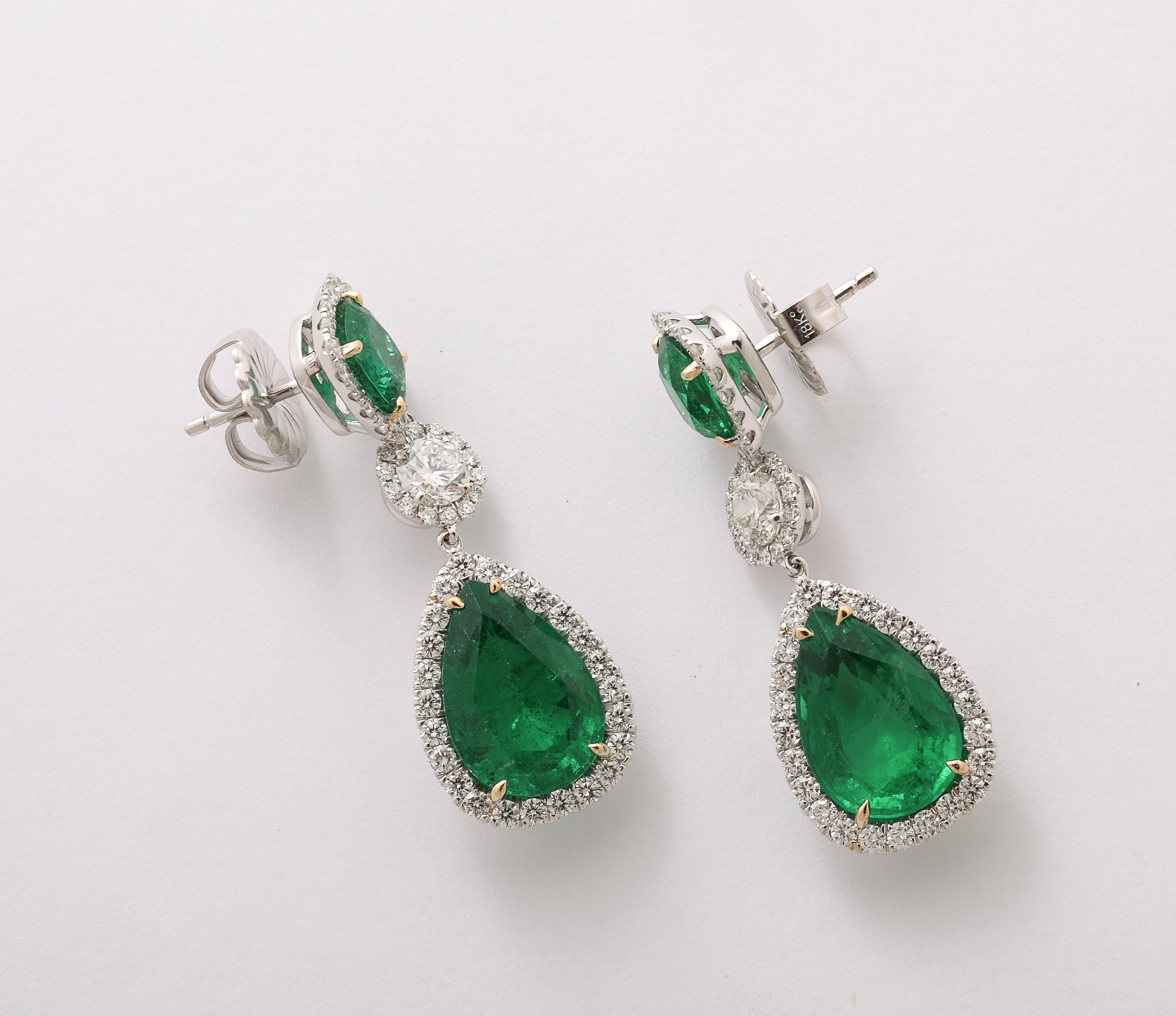 
Incredible Green color! 

Gorgeous emerald and diamond drop earrings. 15 carats of cushion cut and pear shaped emerald drops. 4.31 carats of white round brilliant cut diamonds. 

Set in 18k white gold. 

1.5 inch length. 

Certified by Christian