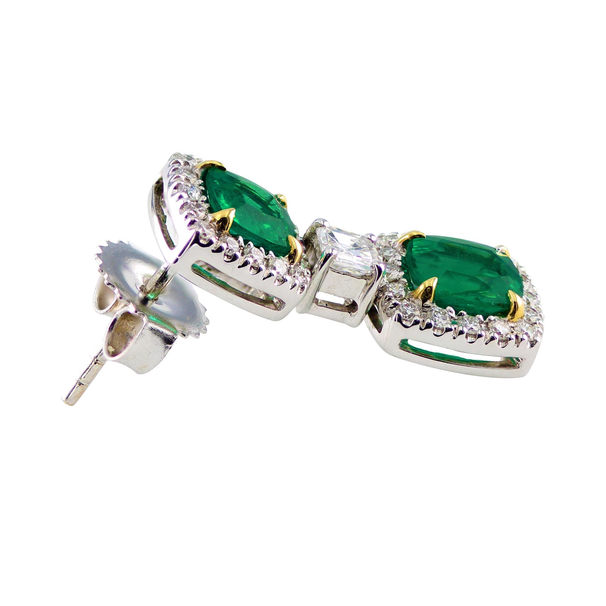 2.47 carat, cushion emerald earrings, separated by a 0.34 carat asscher cut diamond, accented by 0.55 carat round diamonds. 

Set in 18K White and Yellow gold. 

Beautiful and elegant drop earrings that may be worn for any occasion. A lovely gift