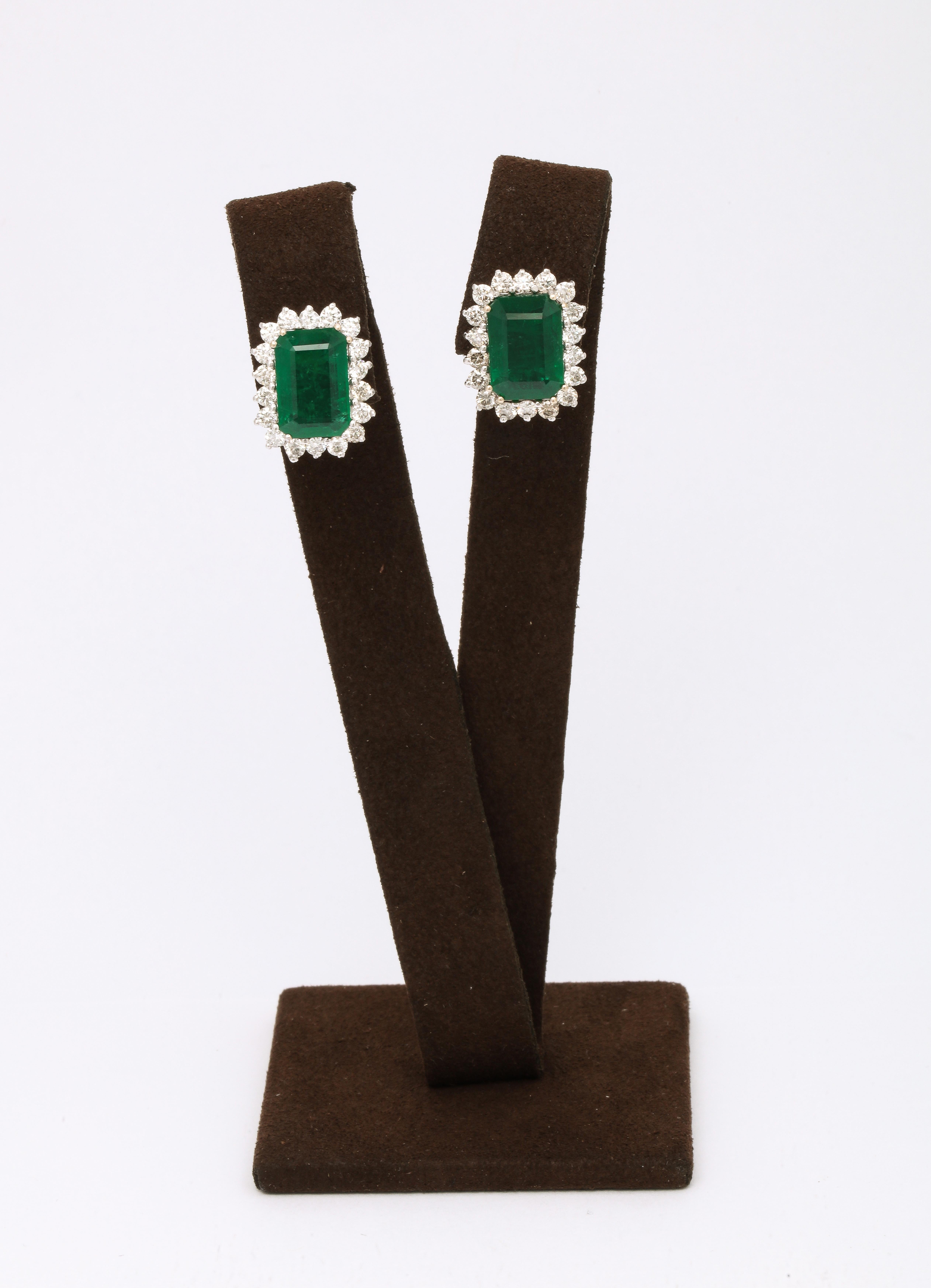 An elegant pair of Emerald and Diamond earrings. 

9.80 carats of Fine Green Emerald 

1.80 carats of diamonds 

18k white gold. 

Approximately .70 x .55 inches — for pierced ears. 

A beautiful gift! 