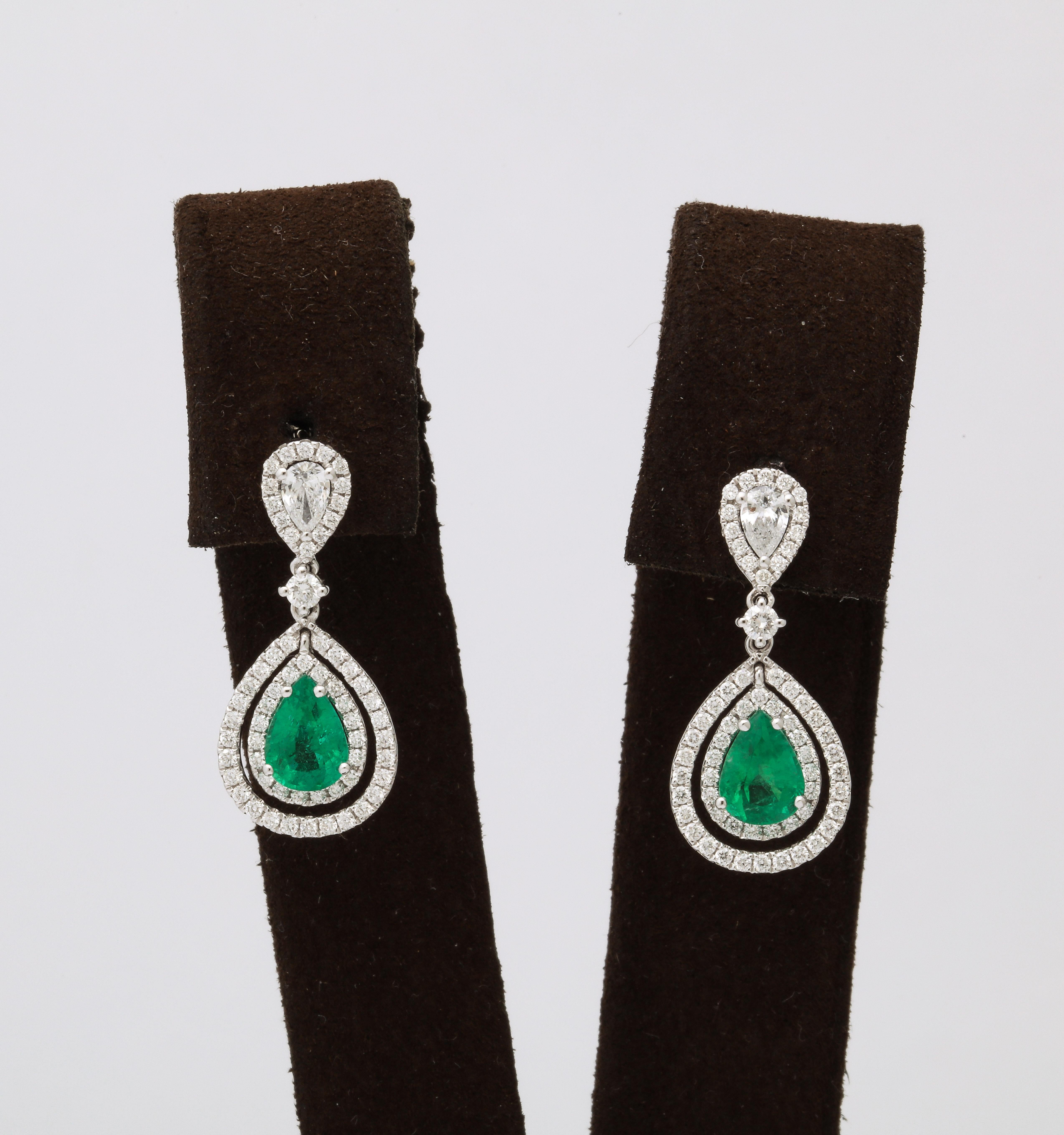 
A BEAUTIFUL pair of Emerald and Diamond dangle drop earrings. 

1.58 carats of fine pear shape green emeralds. 

1.08 carats of white pear and round brilliant cut diamonds. 

18k white gold. 

1 inch length