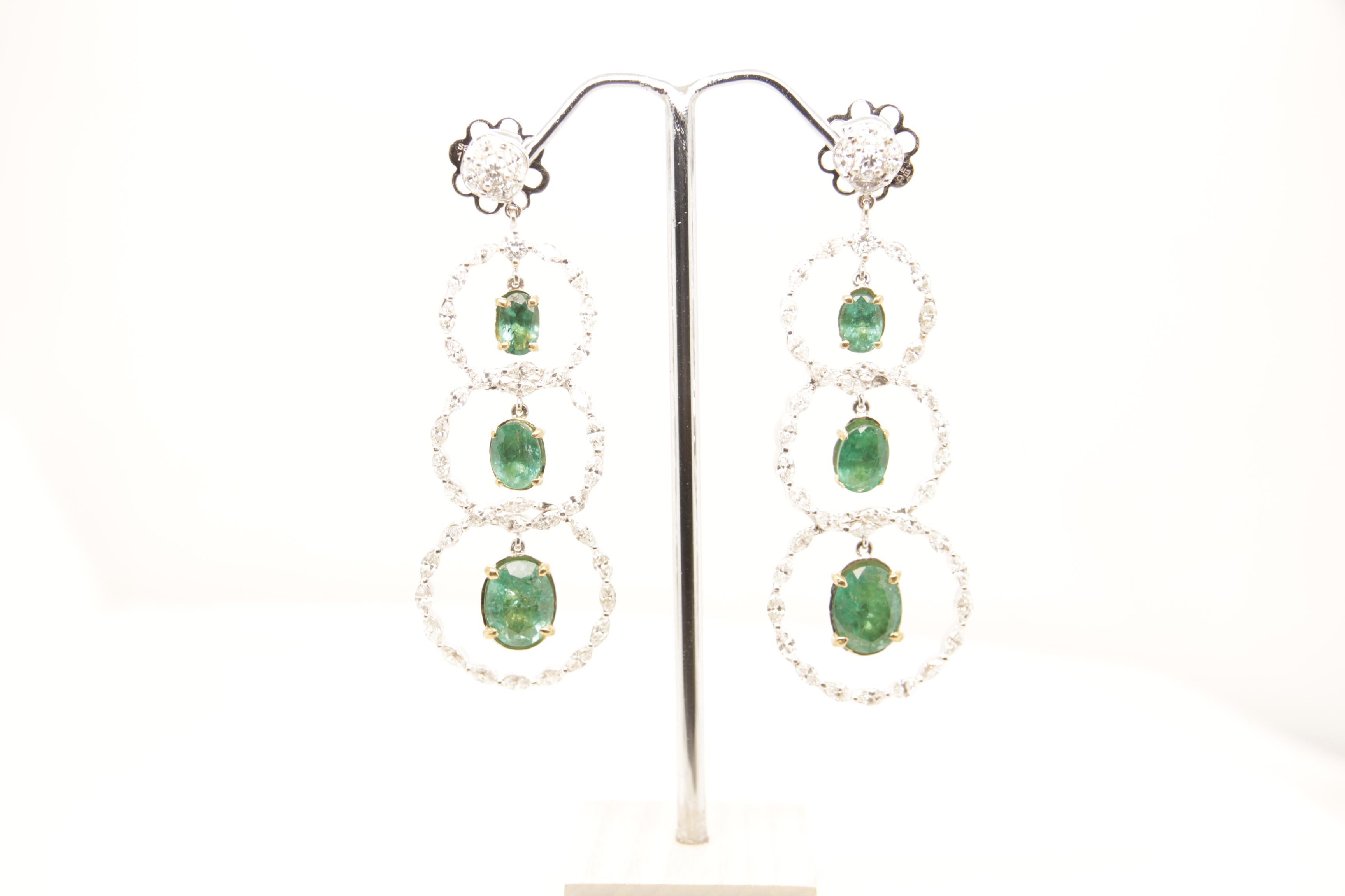 A brand new emerald and diamond earring in 18 karat gold. The total emerald weight is 5.96 carats and total diamond weight is 4.08 carats. The total earrings weight is 15.73 grams.