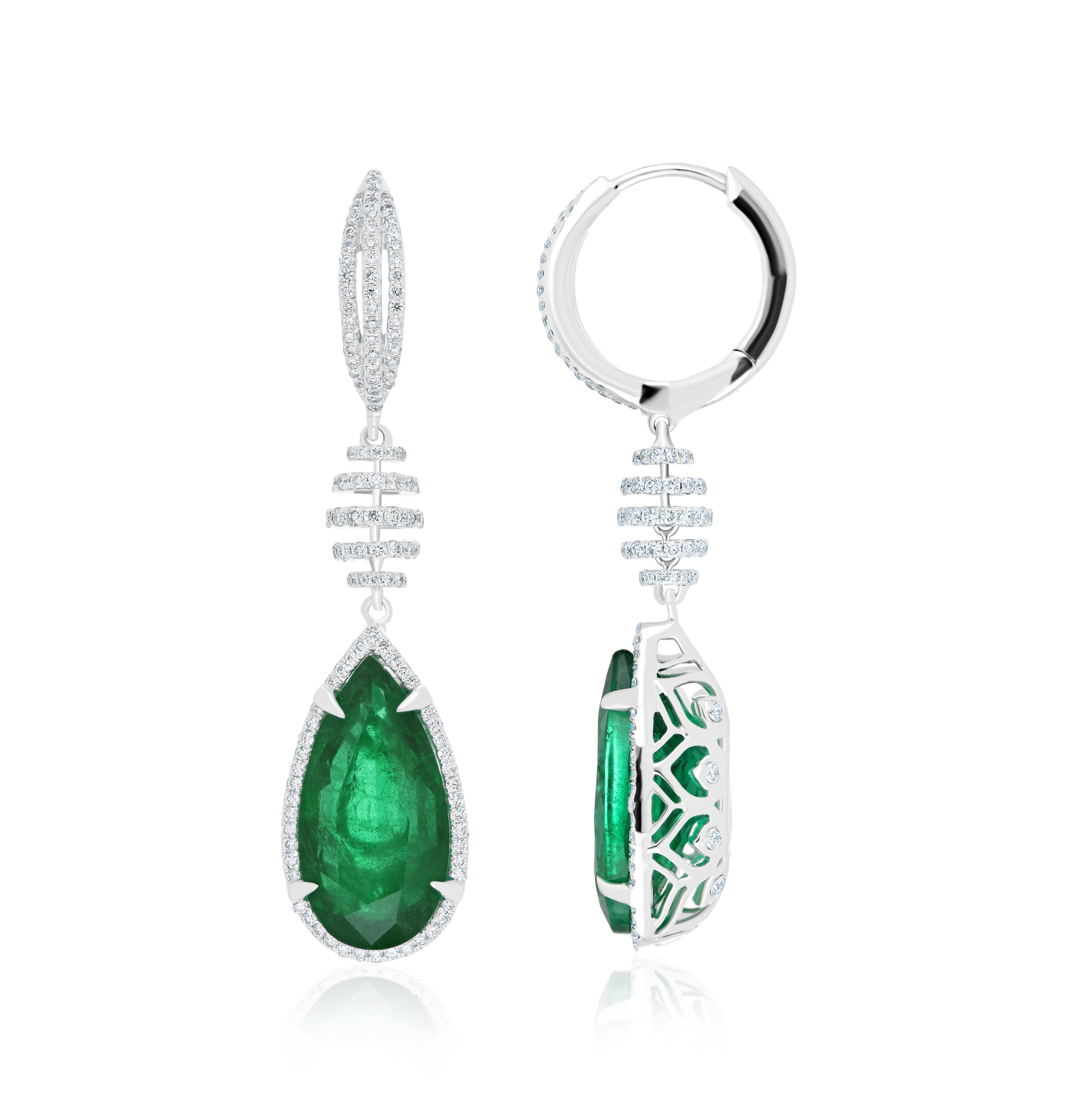 Elegant and Exquisitely detailed White Gold earrings, with 9.46 CT's (total approx.) Emerald Pear Shape, and accented with micro pave Diamonds, weighing approx.  0.99 CT's. (total approx.). total carat weight. Beautifully Hand-Crafted Earring in 18