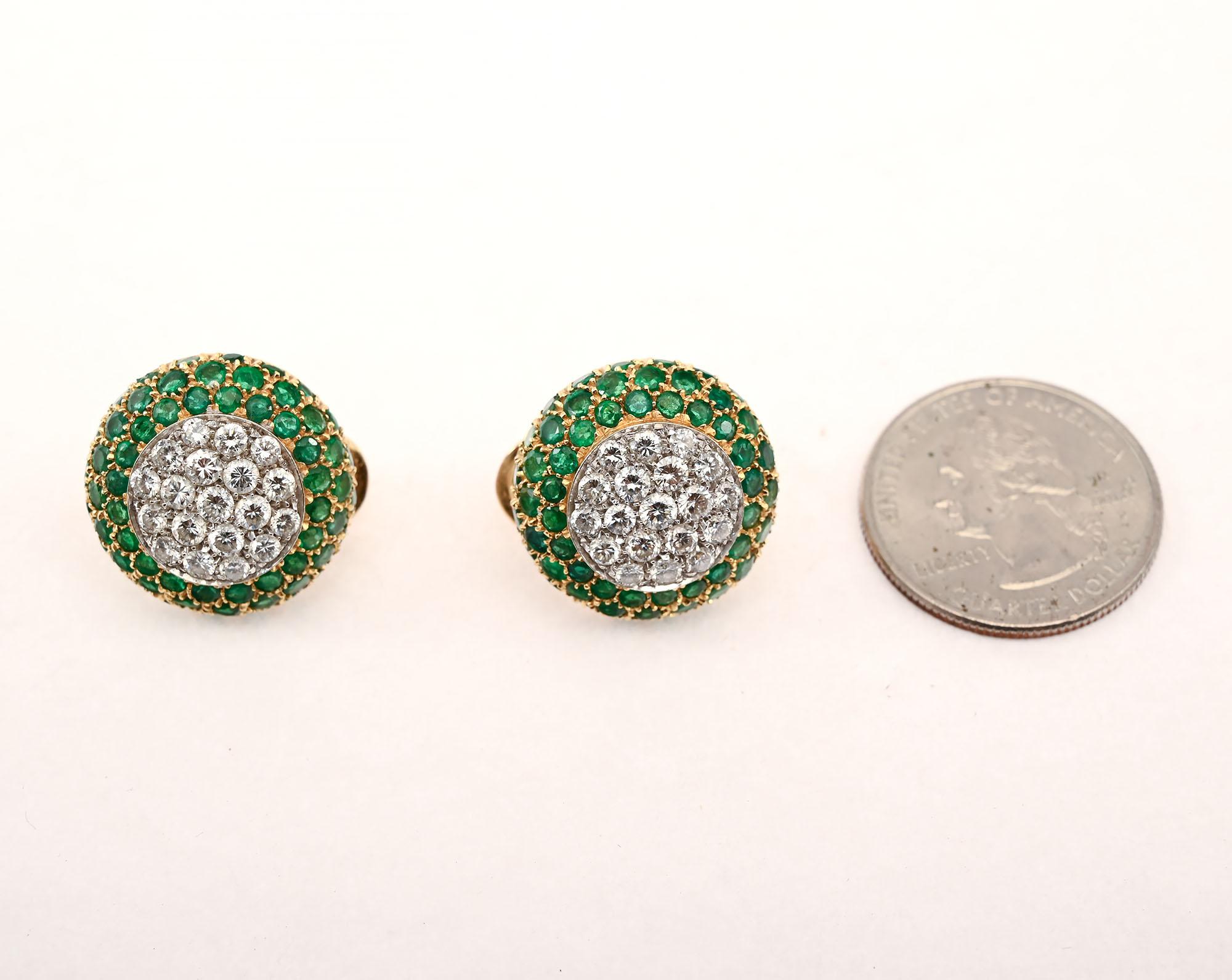 Elegant diamond earrings surrounded by emeralds by Italian designer, Bruno Crivelli. The pave center consists of 4 carats of VS quality diamonds. Surrounding these stones are three rows of round emeralds that weigh a total of 4 carats. The backs are