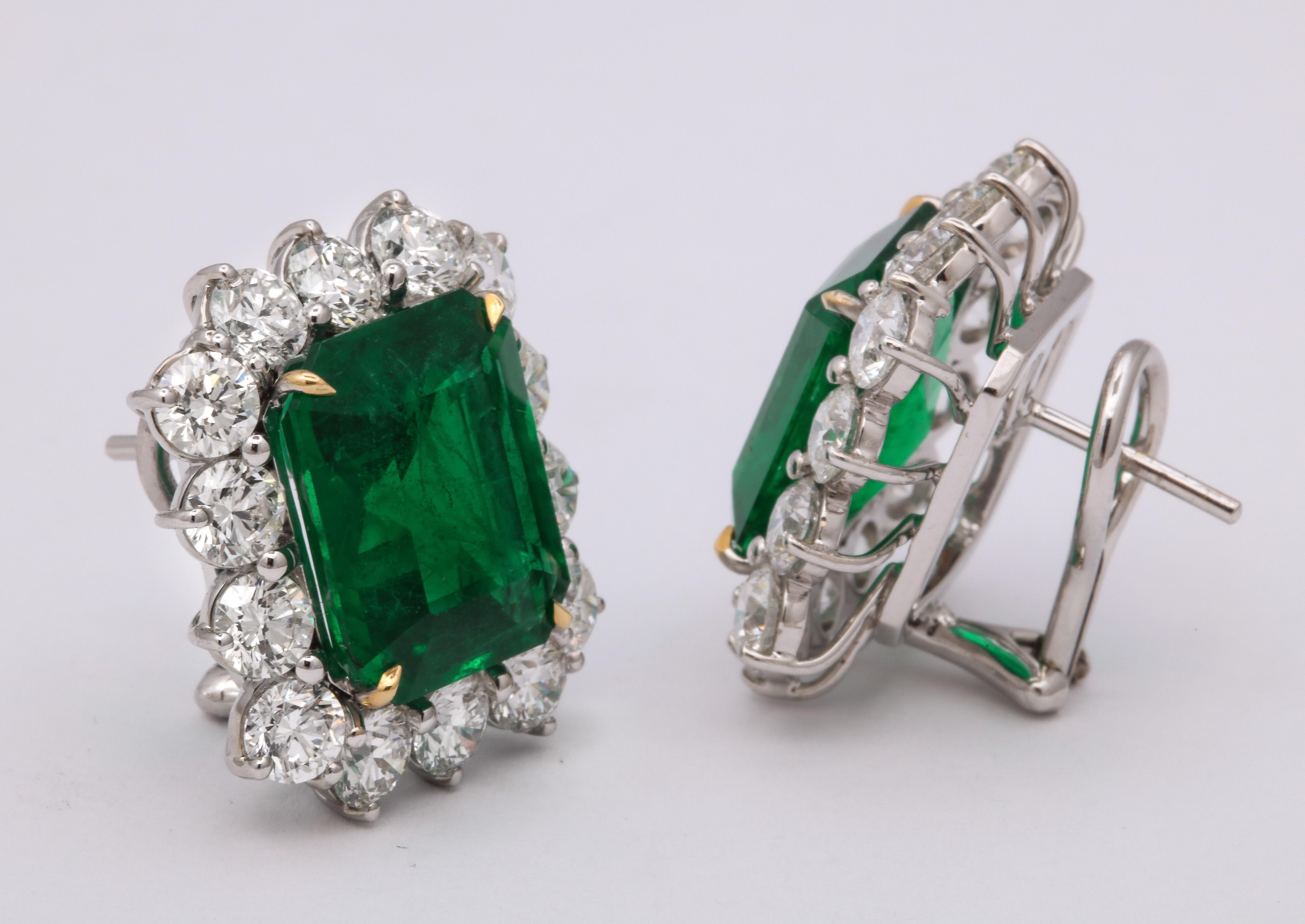 
A fabulous pair of VIVID GREEN emerald cut emerald and diamond earrings. 

14.73 carats of fine green emeralds 

7.03 carats of white round brilliant cut diamonds 

Set in 18k white gold with yellow prongs. 

Certified by Christian Dunaigre of