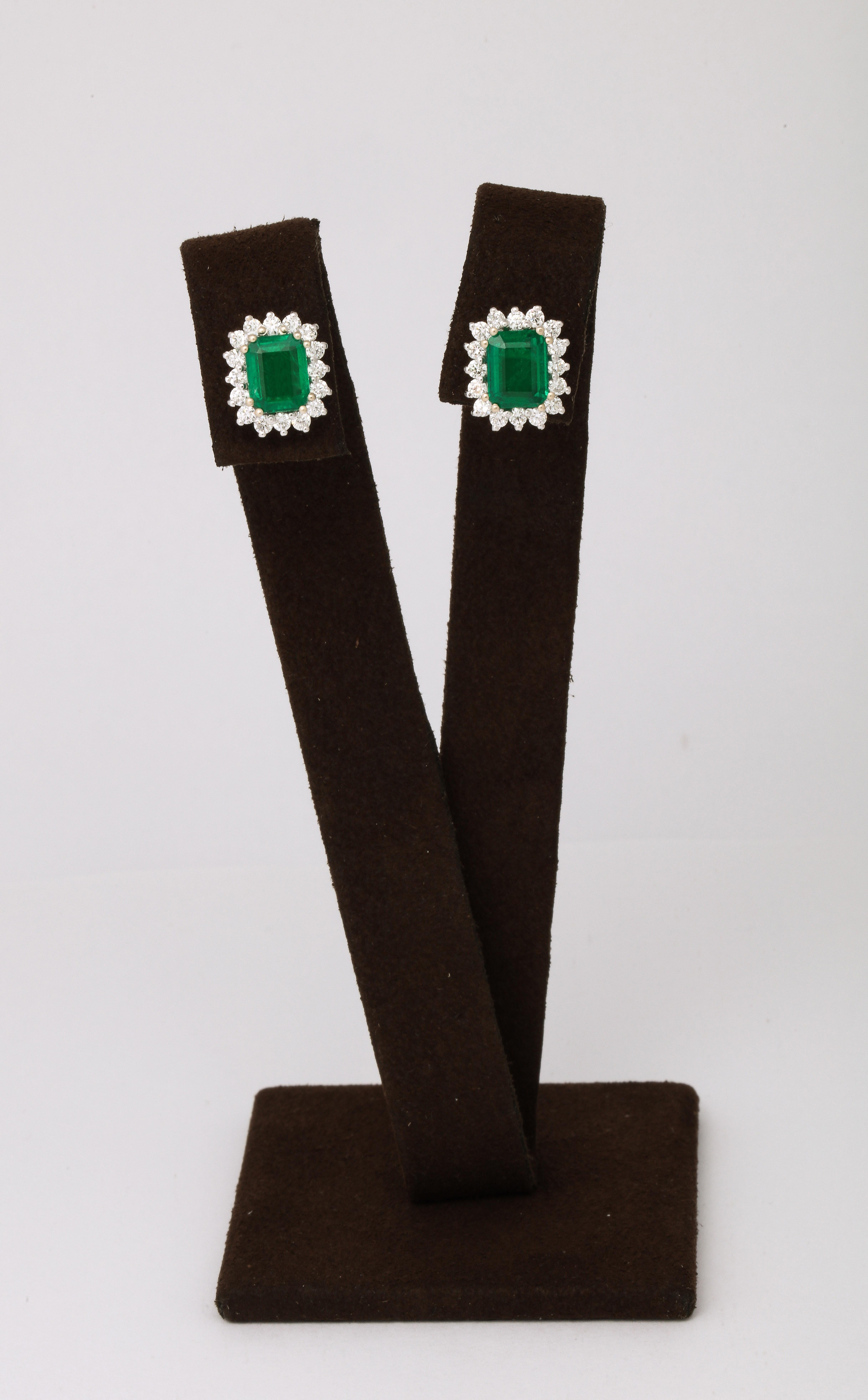 
A stunning pair of timeless emerald earrings. 

7.62 carats of certified Intense Green Emeralds 

1.51 carats of white round brilliant cut diamonds. 

Set in platinum

Just over half an inch in length 

Certified by Christian Dunaigre of