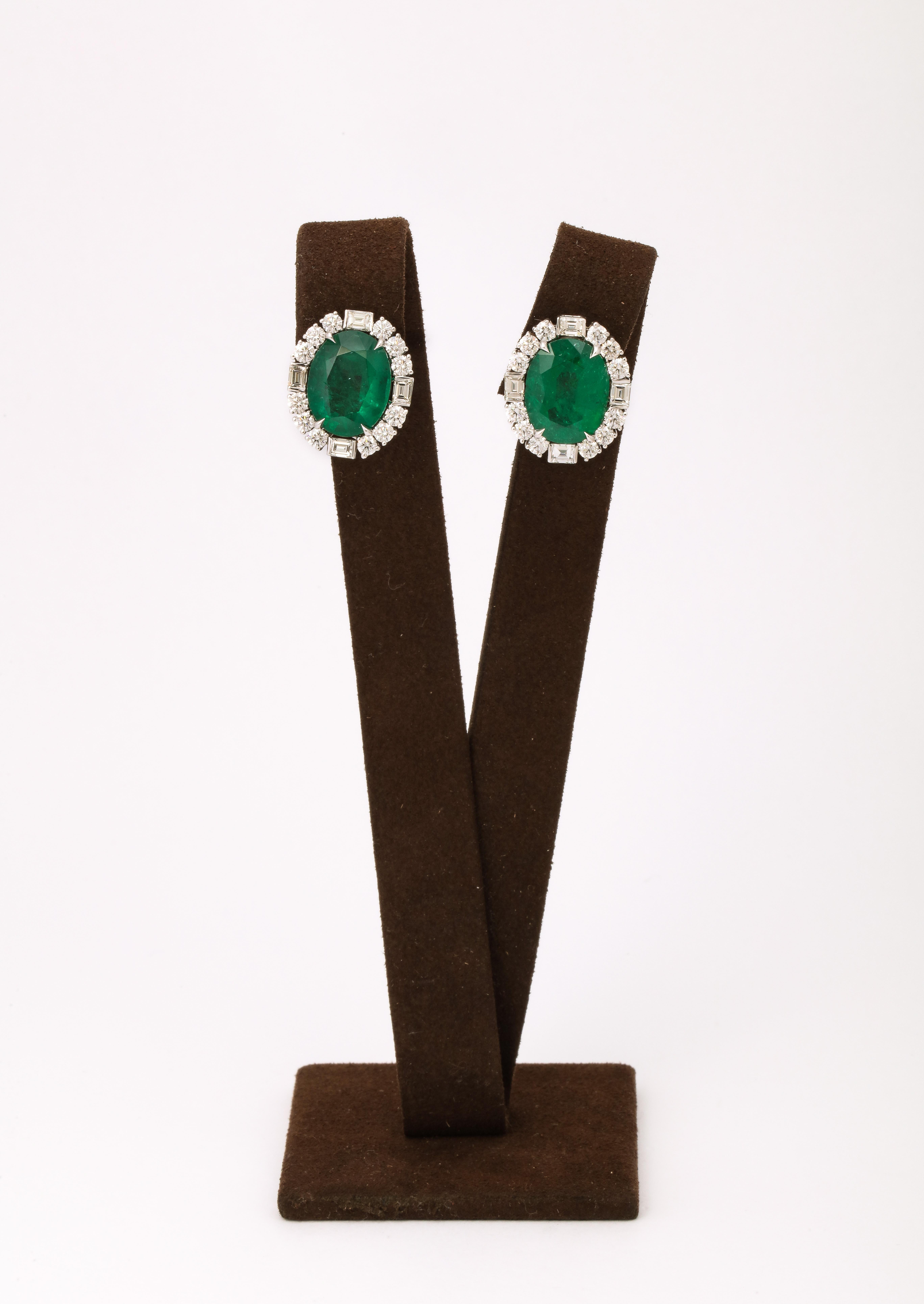 
12.90 carats of certified Intense Green Fine Oval Emeralds.

3.38 carats of white baguette and round brilliant cut diamonds.  

Set in 18 white gold. 

.75 inches long. 

Certified by Christian Dunaigre of Switzerland. 