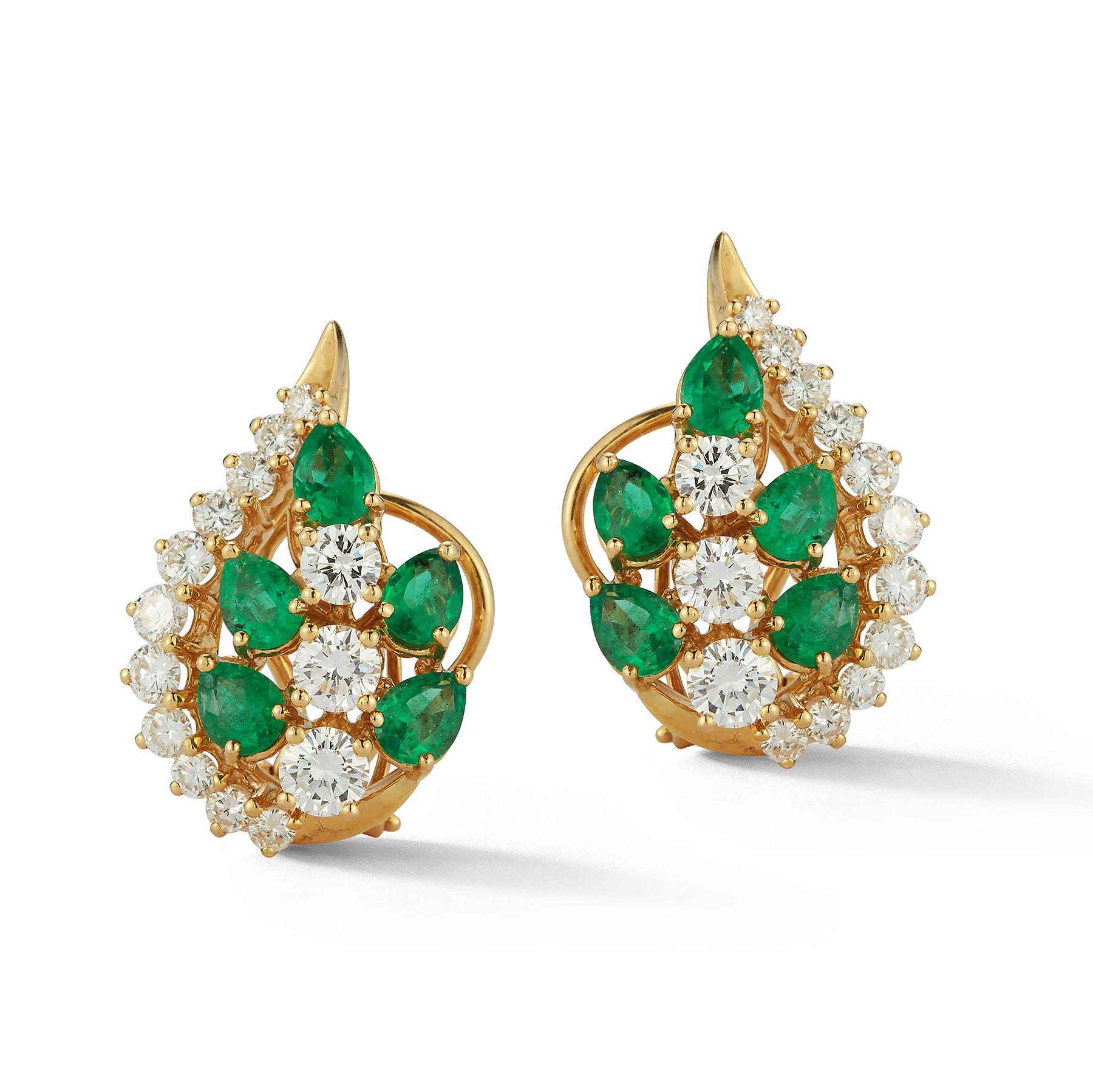 Emerald and Diamond Earrings

5 pear shape emeralds surrounding 3 round cut diamonds and 11 smaller round cut diamonds

Back Type: Clip on with post 

Measurements: .85