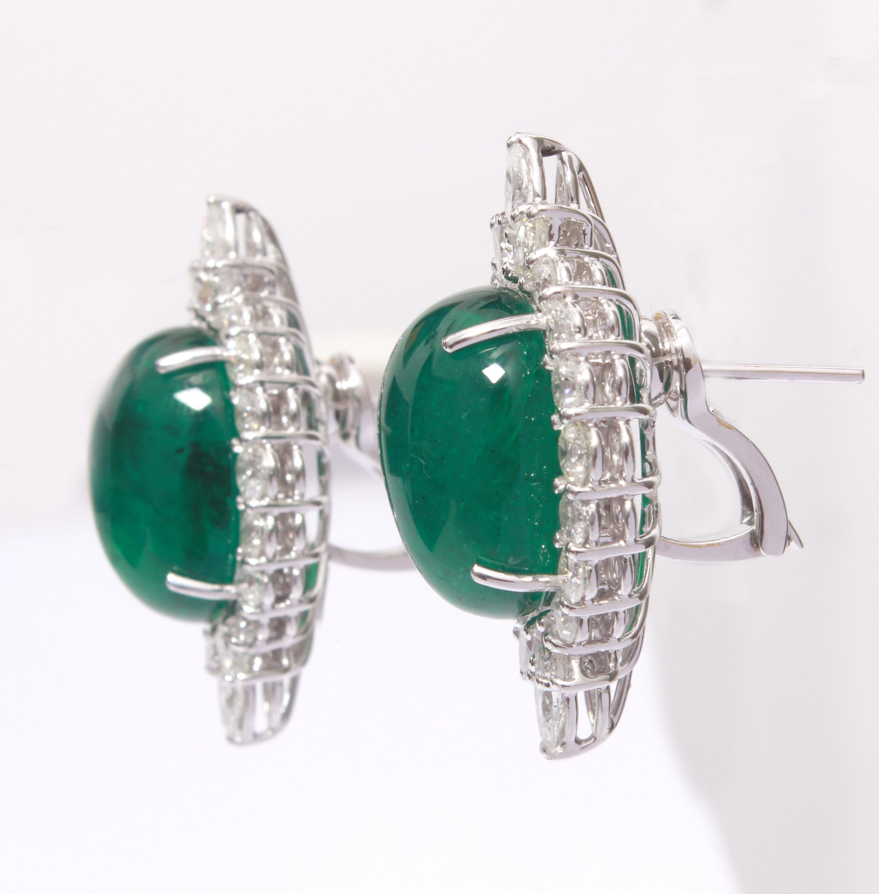 Stunning pair of Earrings embellished with a duo of Zambian emeralds weighing 28.87 carats, with 12 pieces of pear cut white diamonds weighing 2.19 carats, and 24 pieces of round cut white diamonds weighing 2.25 carats and 4 pieces of round cut