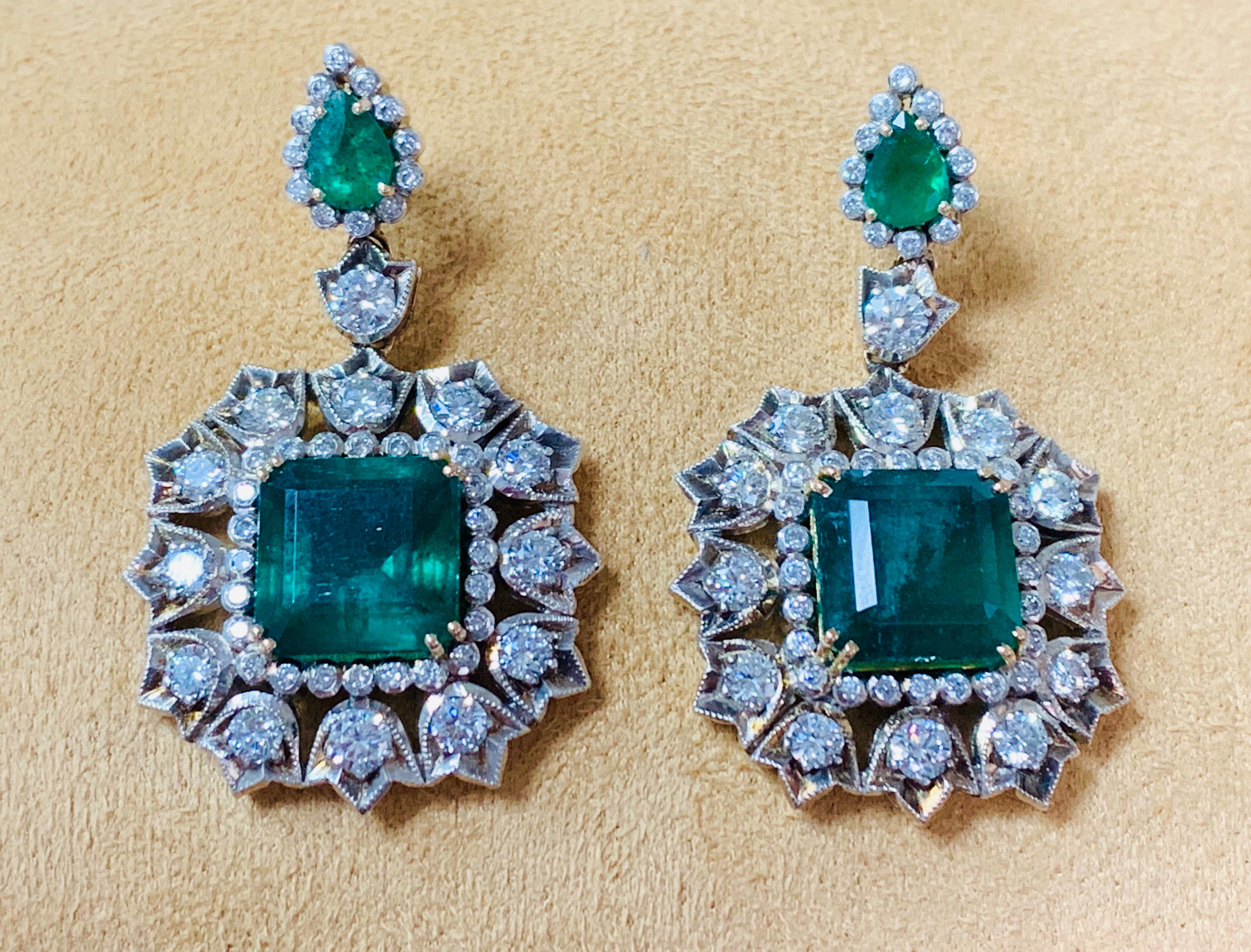 Moguldiam Inc Emerald and diamond earrings handmade in 18k gold. 

Emerald weight : 18.40 carat  
Diamond weight : 5.40 carat 
Metal : 18K Gold 
