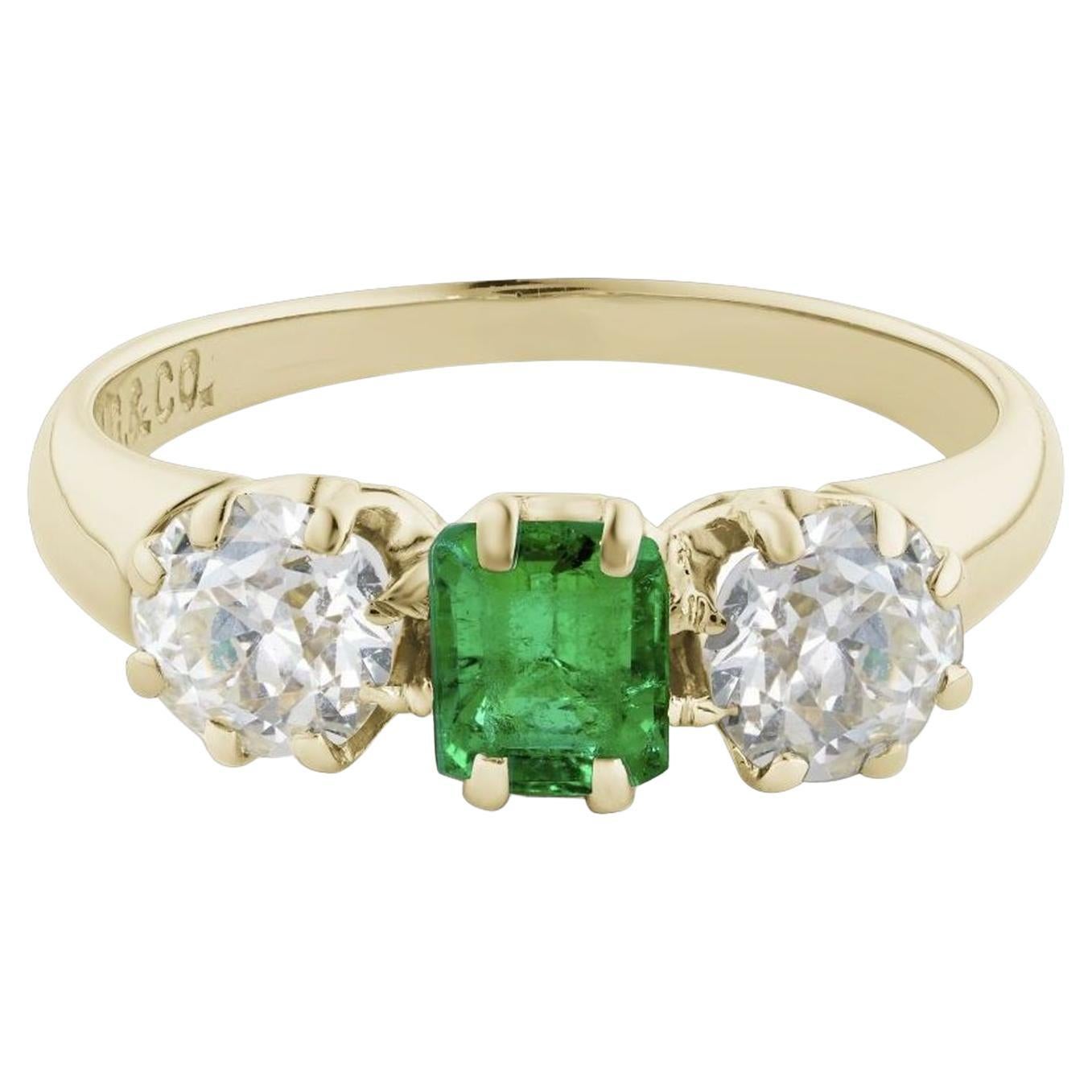 Simply Beautiful! Finely crafted Three Stone Emerald and Diamond Ring. Centering a Hand set securely nestled Emerald-Cut Emerald weighing approx. 0.46 Carat with an Old European-Cut Diamond on either side; approx. 0.35 Carat, approx. 0.70tcw. J-K VS