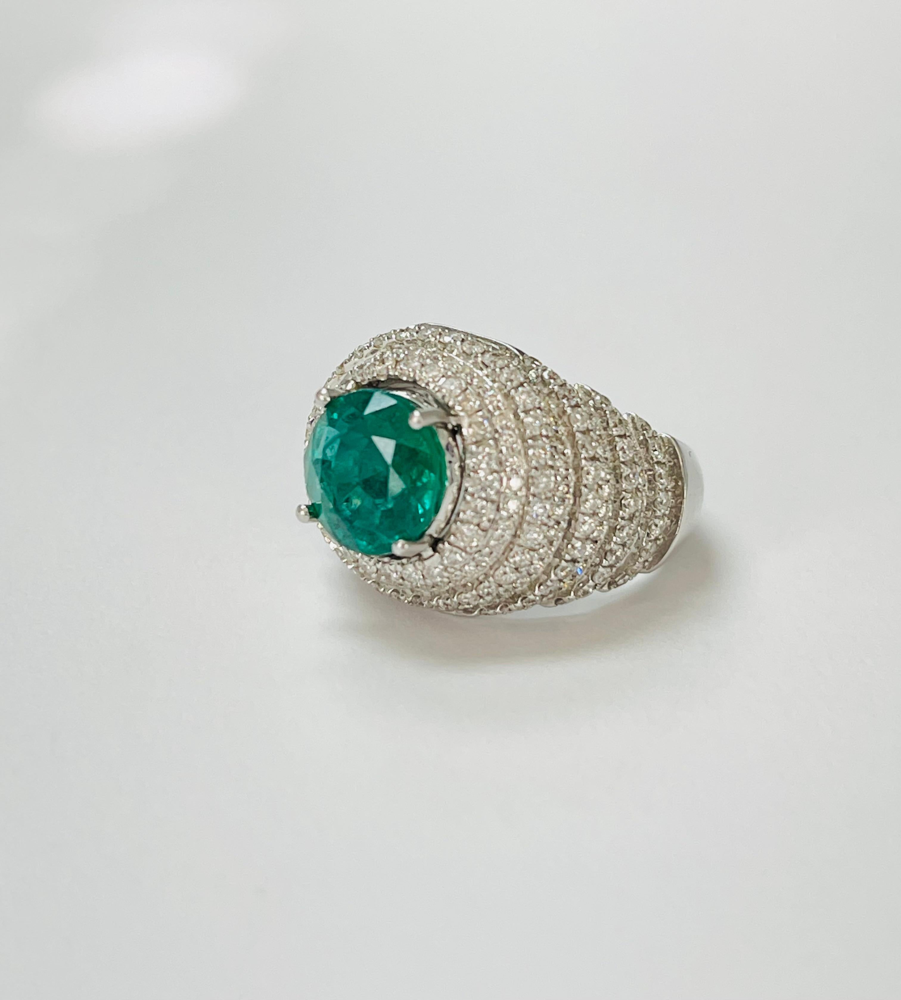 Contemporary Emerald And Diamond Engagement Ring In 18K White Gold. For Sale