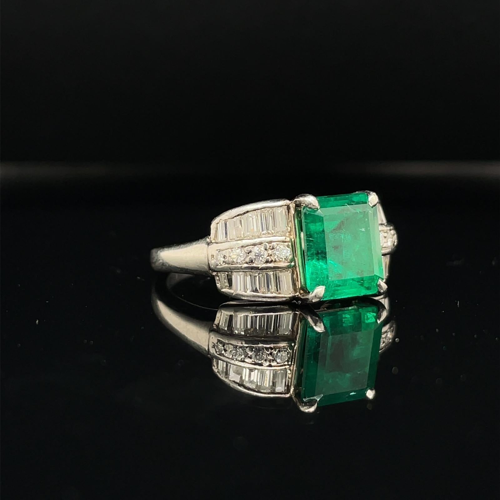 An emerald and diamond platinum engagement ring in an Art Deco style, circa 1950

This ring is centrally set with an beautiful 2.07 carat emerald cut emerald which is claw set in platinum The emerald has an intense and vibrant deep green colour to