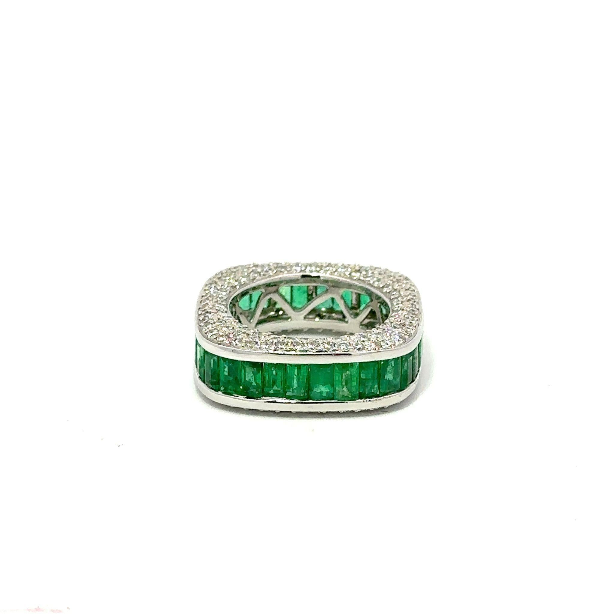 Modern cushion-shaped band with pavé diamonds and featuring channel-set emerald-cut emeralds.  Circa 2000.  The 212 round diamonds total 2.25 carats, G-H color and VS2-I1 clarity.  The 34 emeralds total 5.65 carats and have very nice saturation of