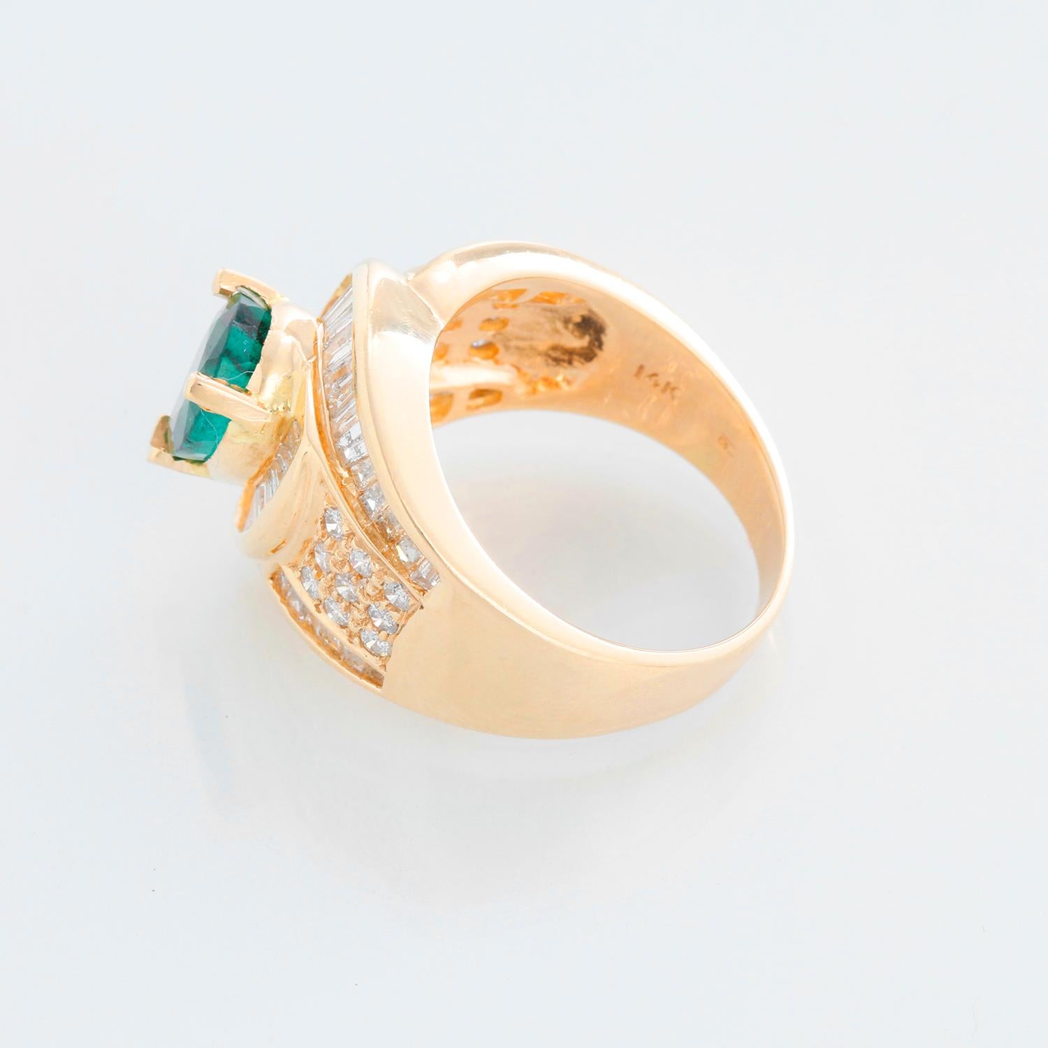 Emerald and Diamond Fashion 14K Yellow Gold Ring Size 7 1/4 - The ring features a 3-prong setting containing one center pear faceted emerald measuring 9.50 x 7.07 x 3.70 mm. Estimated weight 1.18 carats. The emerald is surrounded by 38 baguette cut