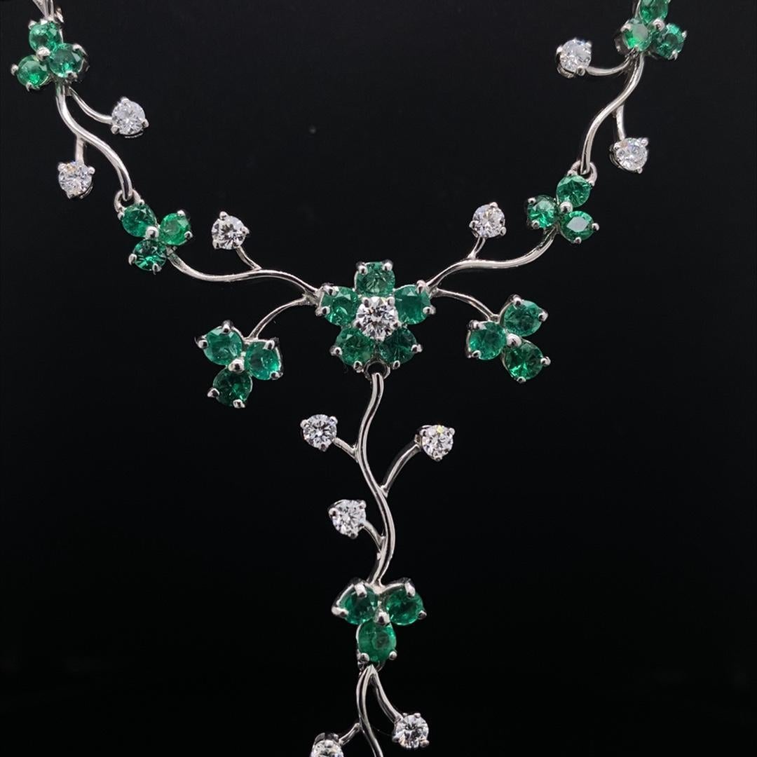 An emerald and diamond floral necklace 18 karat white gold.

Each flower in this elegant contemporary necklace comprises of round cut emerald petals and a central round brilliant cut diamond, all the buds are interlinked onto an articulated 18 karat