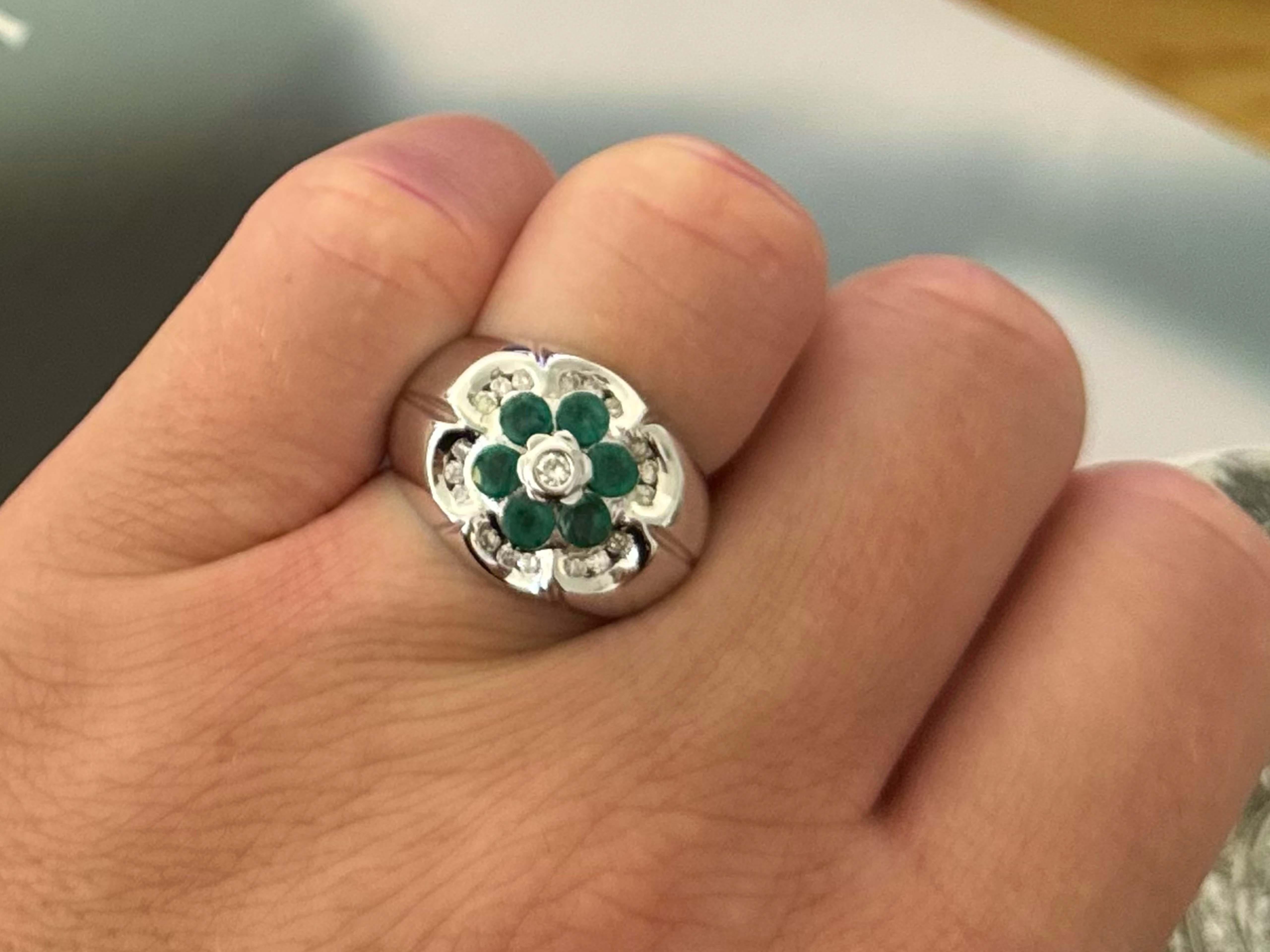 Ring Specifications:
​
​Metal: 14K White Gold

Ring Size: 6

Ring Height: 15 mm tall

Ring Weight: 7.3 grams

Emerald Count: 6 round green emeralds (~3.3 mm in diameter)

Emerald Carat Weight: ~0.78 carats

Diamond Shape: 19 round brilliant cut