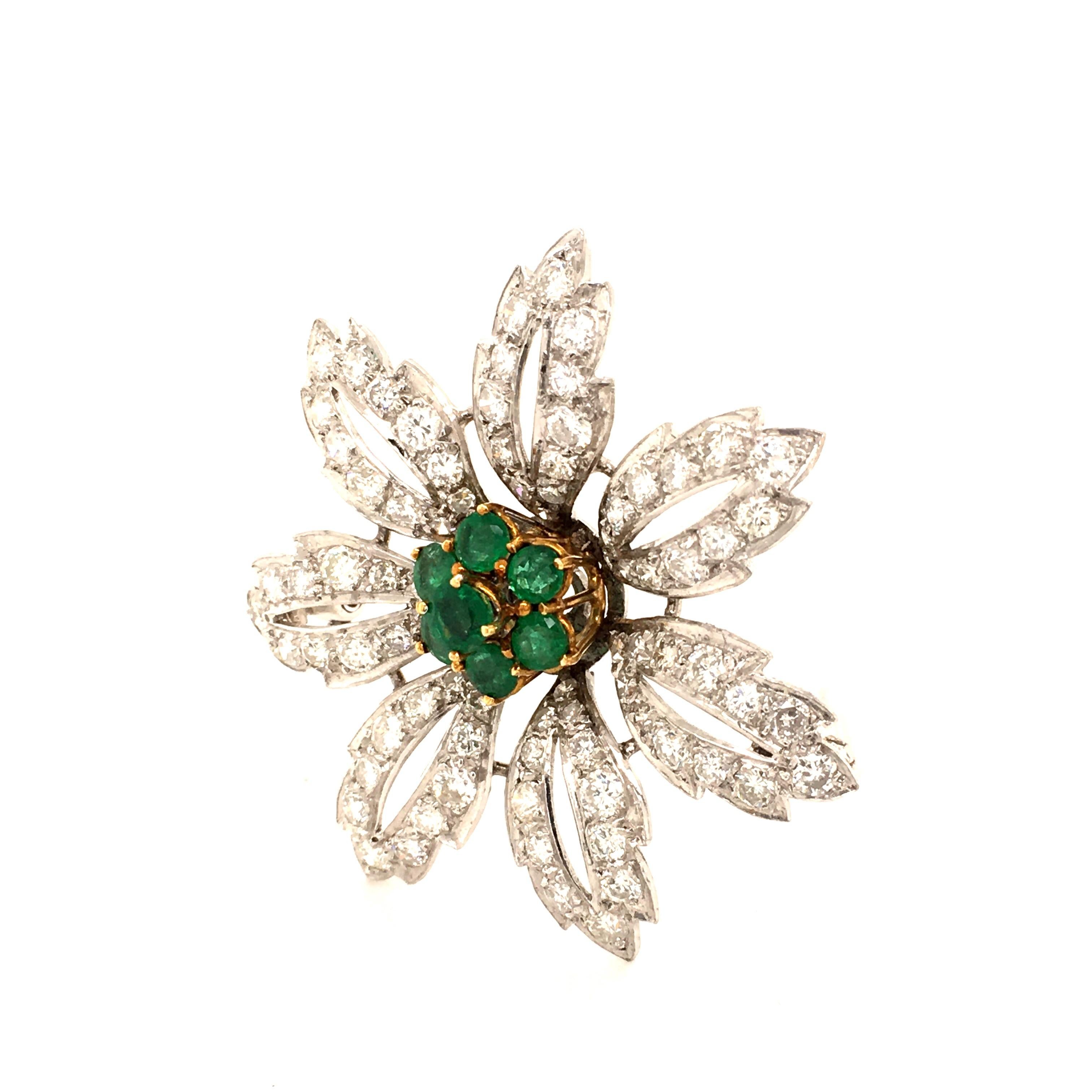 The centre of this charming flower brooch in 14 karat white and yellow gold is set with 7 round-cut emeralds, total weight approximately 1.10 carats. The seven slightly curved leaves are set with 84 brilliant-cut diamonds of H/I-colour and si