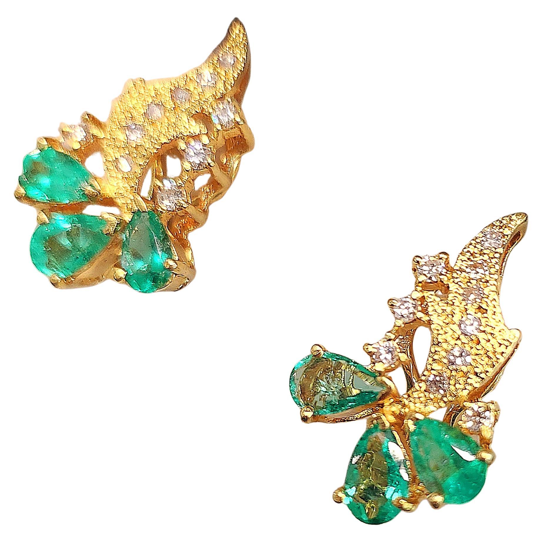 18k yellow gold earring with back clip decorted with natural rich green color emeralds estimate weight 0.80 carats and brilliant cut diamonds total earrings gold weight 7.70 grams and 1.5 cm lenght