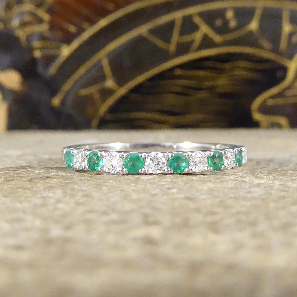 An eternity ring with a difference. This half eternity ring features 7 alternating Emeralds with 6 Diamonds giving it full sparkle across the whole head of the ring. All the stones round cuts in claw settings in 9ct White Gold to compliment them.