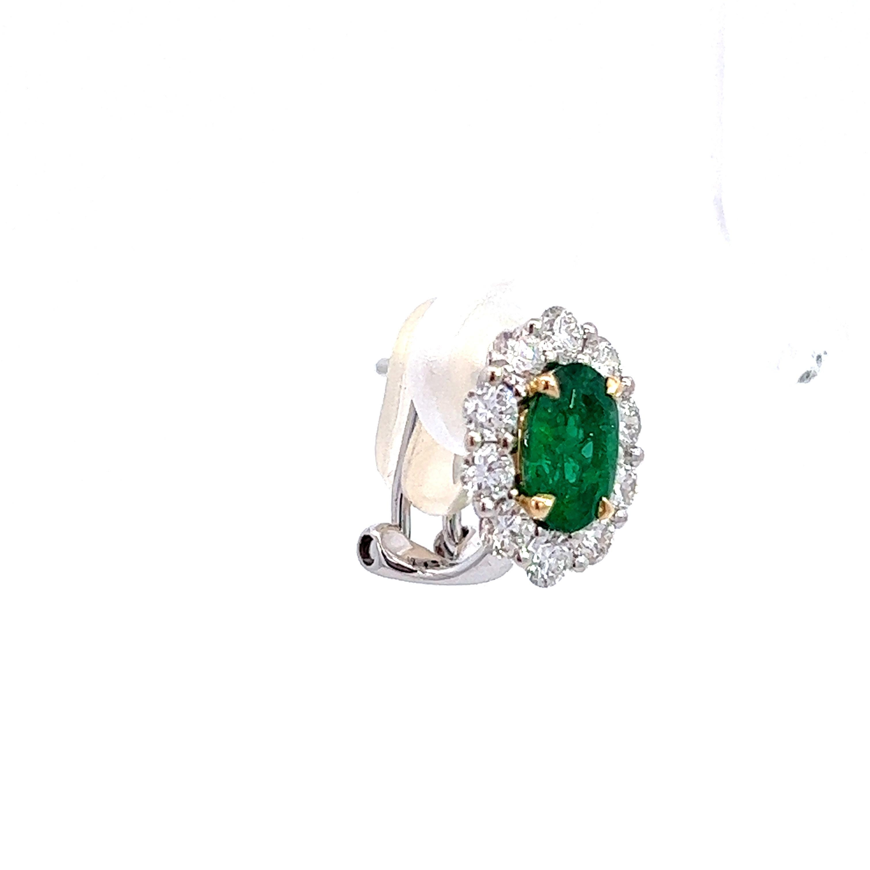 Oval Cut Emerald and Diamond Halo Earrings in 18KW Gold For Sale