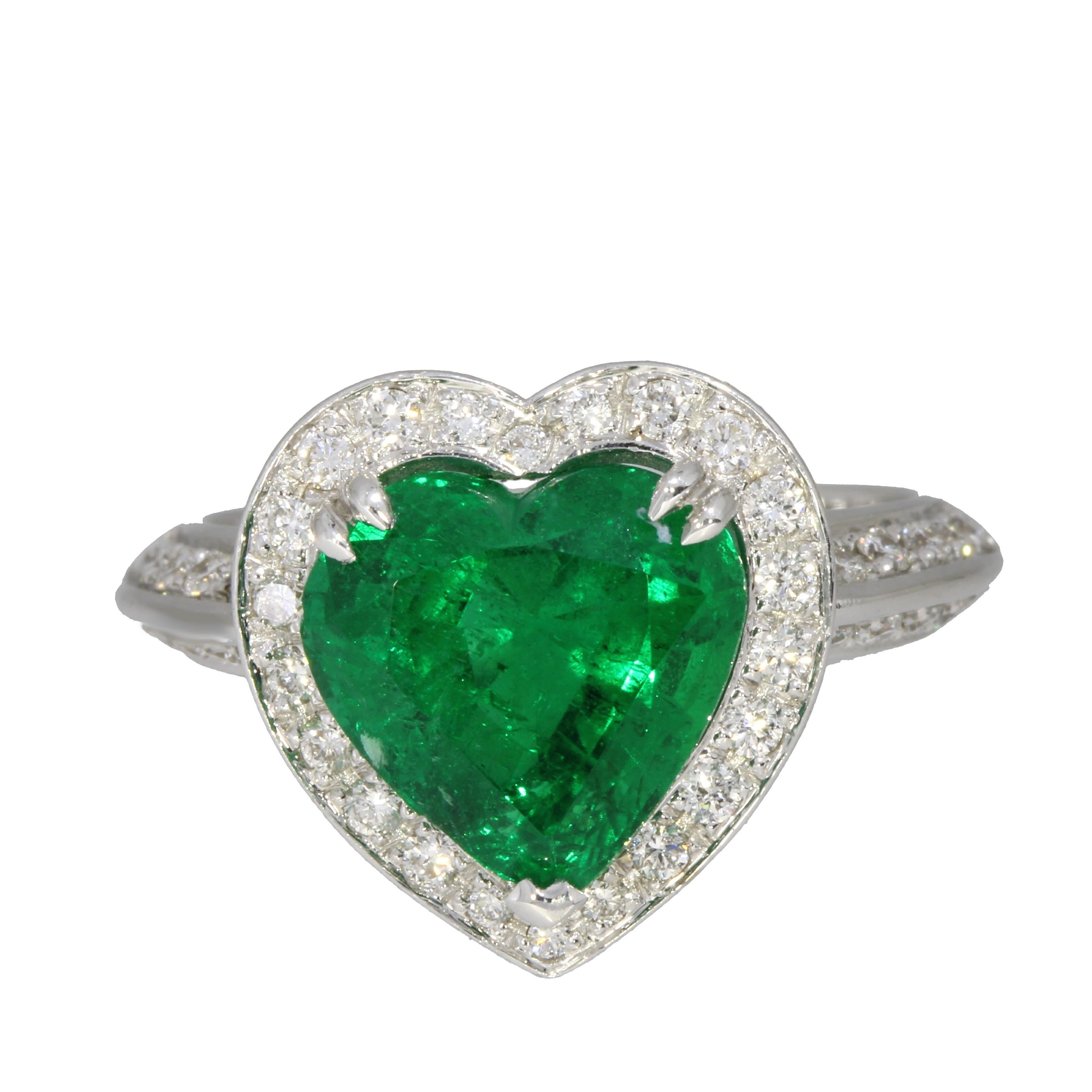 Certified Heart Cut Natural Emerald encircled by a delicate heart shaped row of brilliant cut white diamonds. 

- 18 Karat White Gold 
- 4.13 carats Heart Cut Natural Emerald Vivid Green CEE(O) Minor - GIL certified
- 0.80 carats White