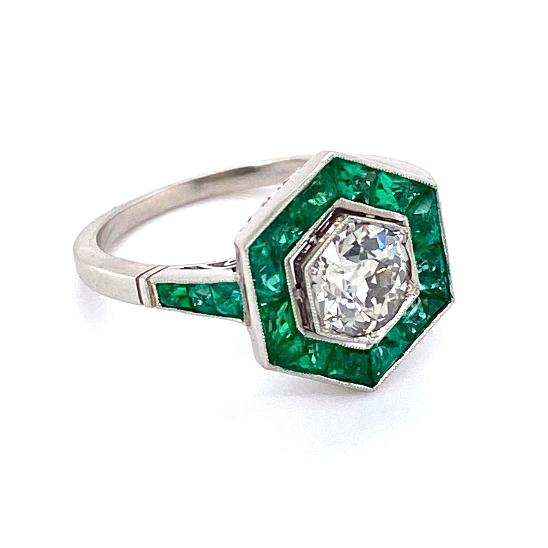 Elegant & finely detailed Cocktail Ring, center set with an Old European Cut Diamond, approx. 0.90 Carat; color J; clarity VS, surrounded by Emeralds weighing approx. 2.60 Carats, total weight. Hand crafted in Platinum in hexagon form. The ring