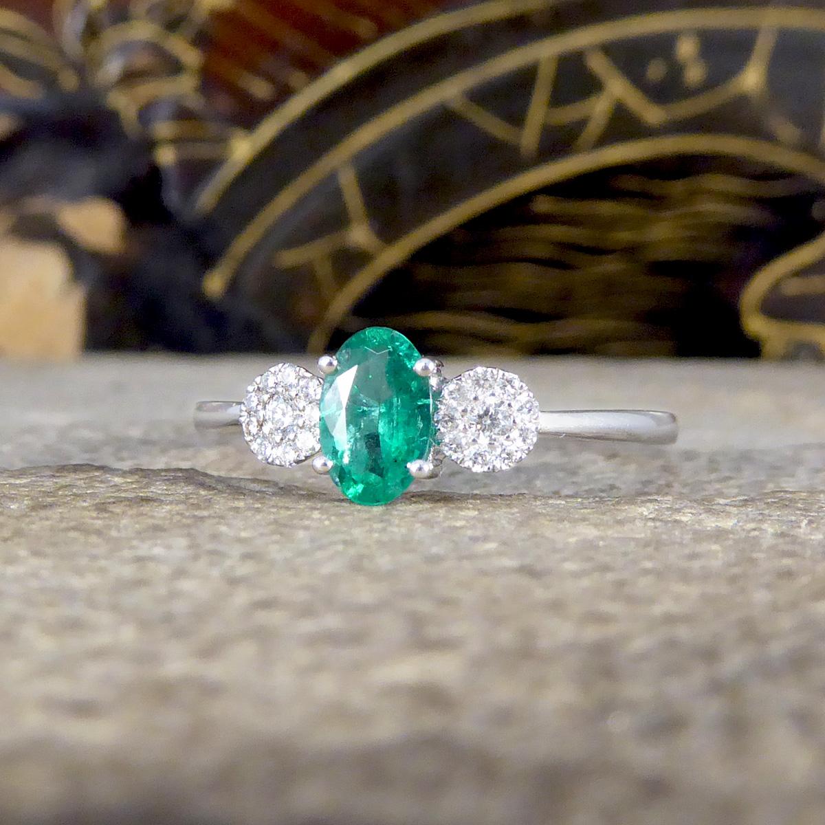 Oval Cut Emerald and Diamond Illusion Three Stone Ring in 18ct White Gold For Sale