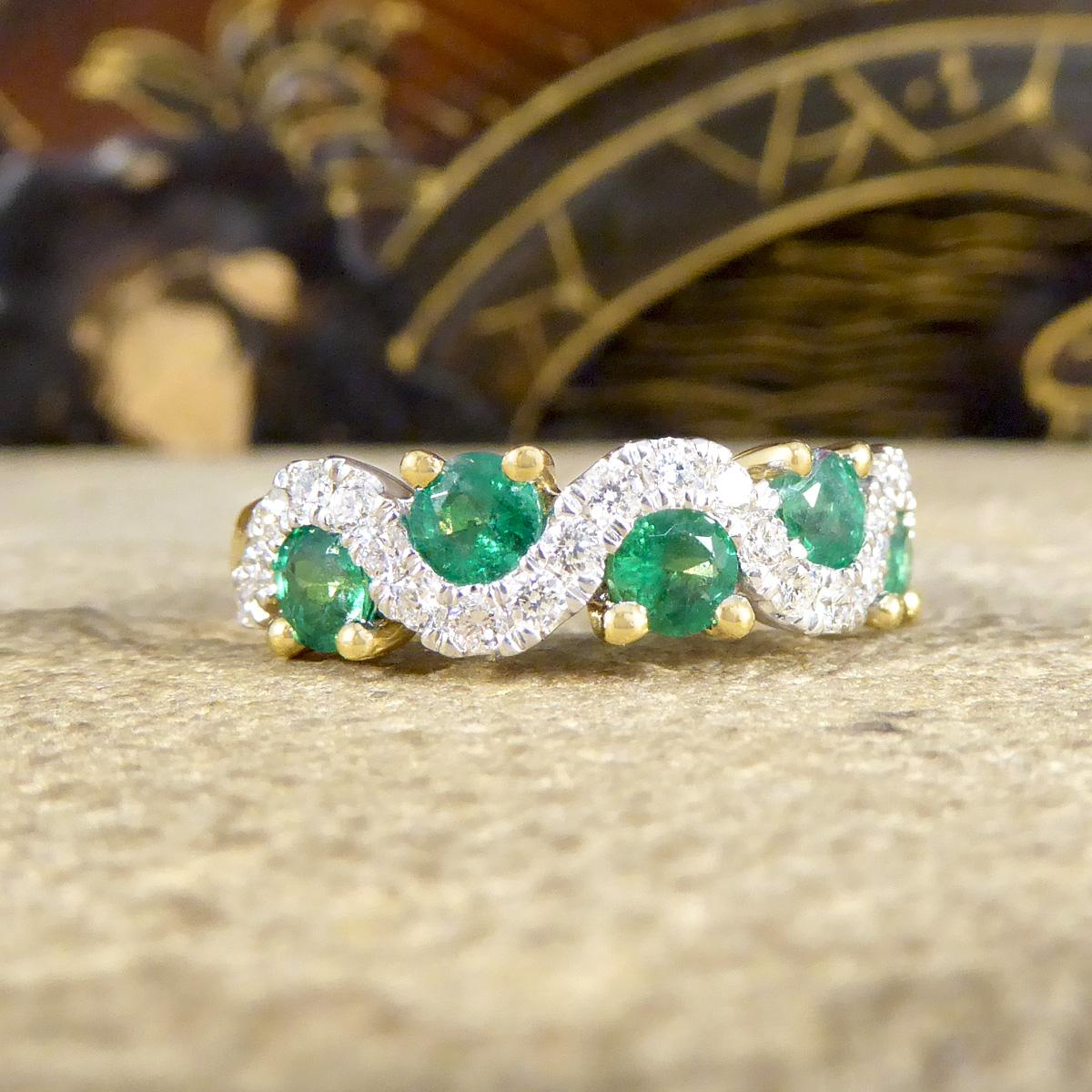 This lovely contemporary ring is the perfect style to be worn on its own or as a stackable ring. A beautiful half eternity ring with a difference! It sparkles across the whole face of the finger with round cut Emeralds weighing 0.13ct each