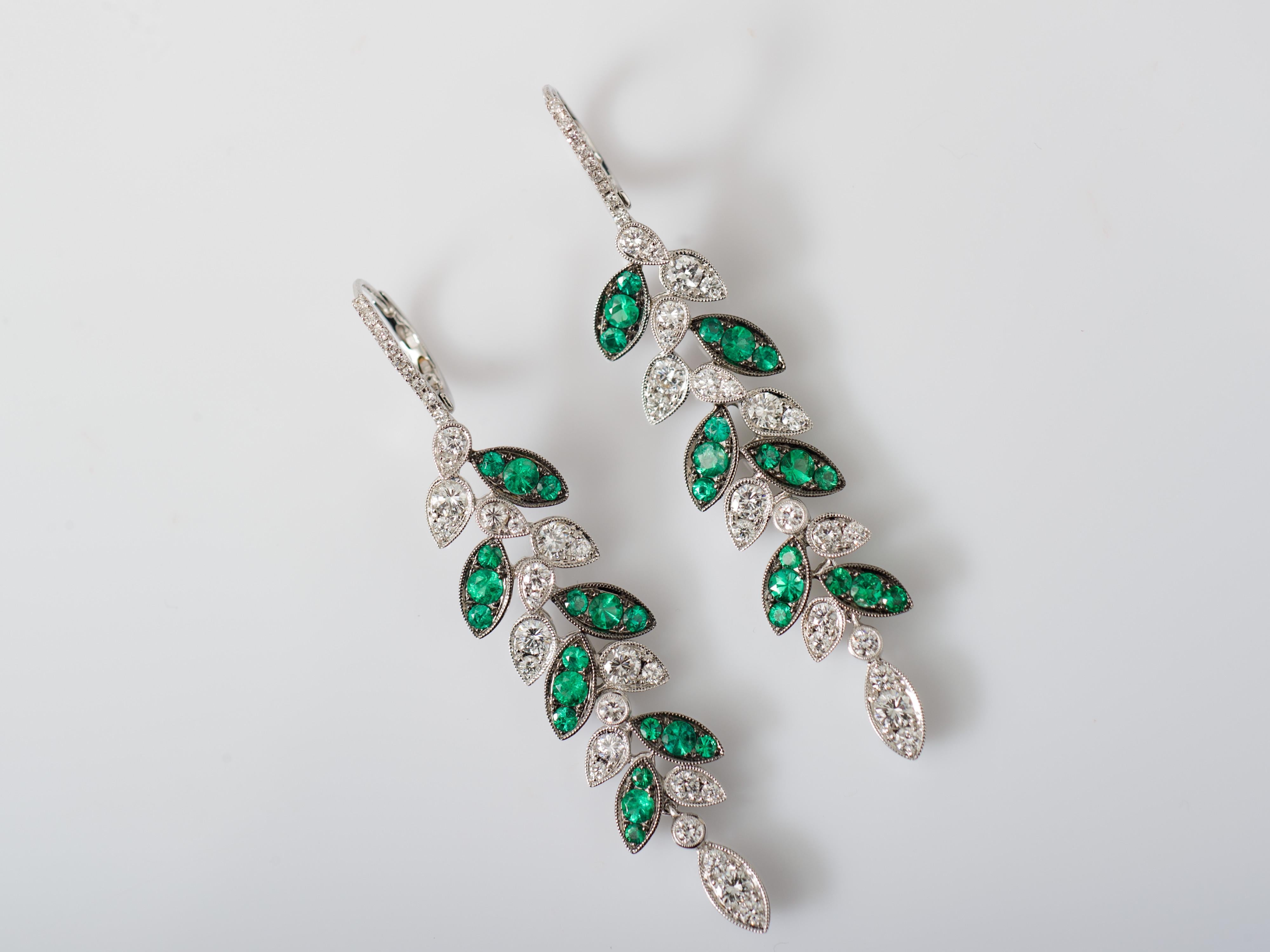Designed to resemble an elongated leaf, our earrings are crafted in 18k white gold and each small leaf individually set with round Emeralds and Diamonds to give the illusion of larger marquise shaped stones. The earrings are made flexible so they