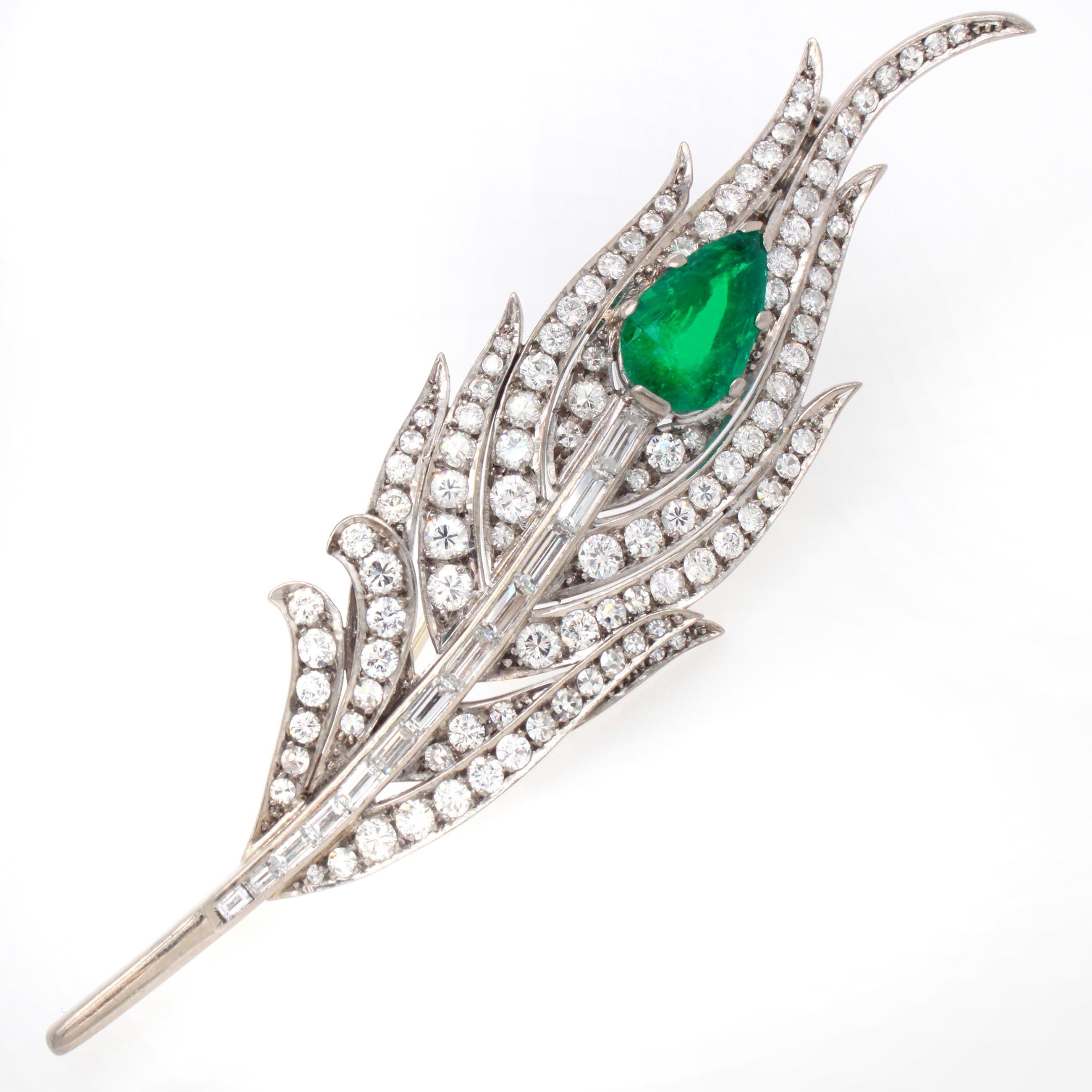 An emerald and diamond brooch in the design of a peacock feather. The pear shaped emerald has a vivid green colour and beautiful crystal. It weighs approximately 2.75 carats. The individual feathers are set with round brilliant cut diamonds and the