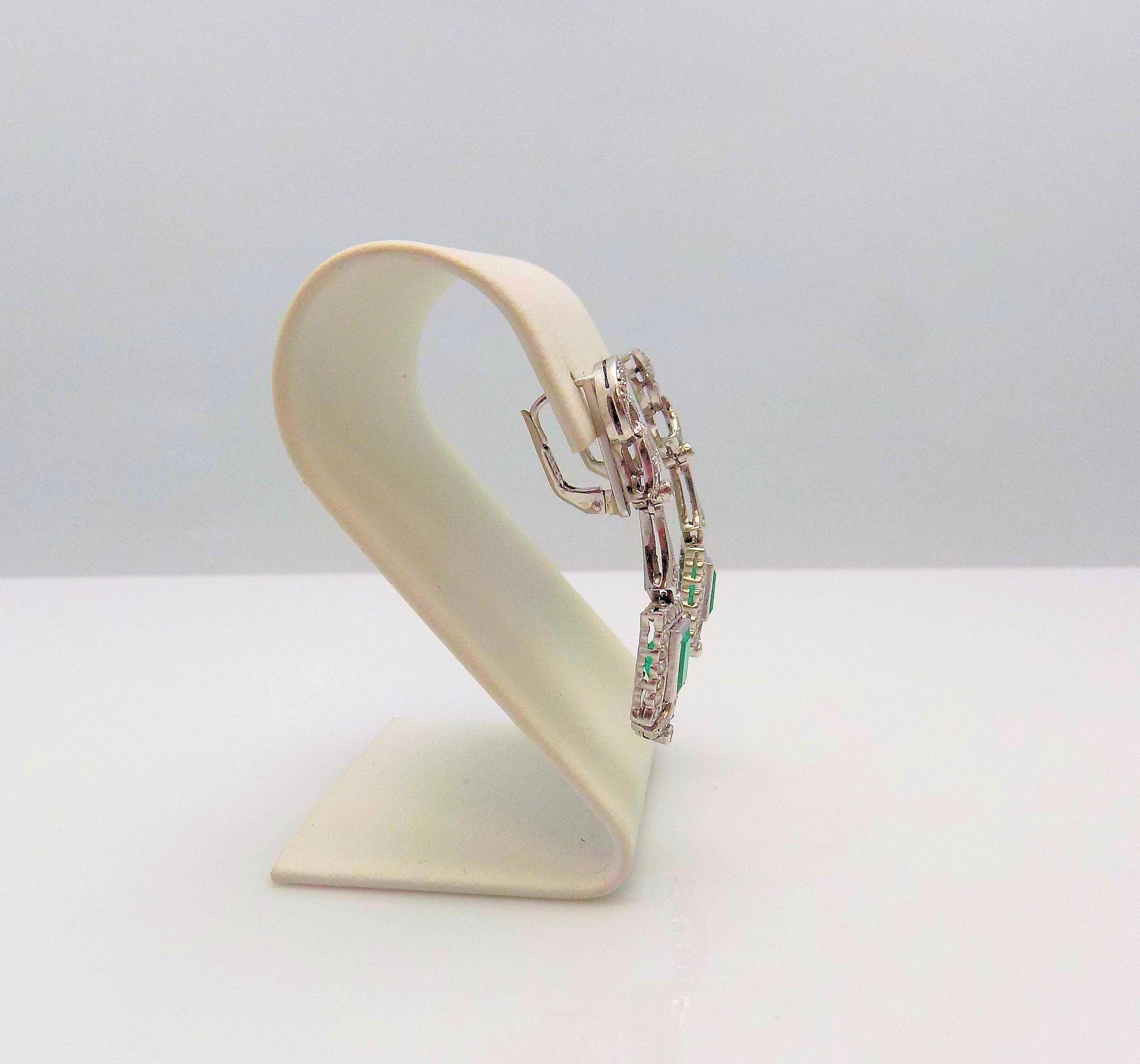 Pair 12 Karat White Gold Leverback Pendant-Style Earrings featuring 2 Rectangular Emeralds 1.75 Carat Total Weight; 65 Single Cut Diamonds (1 Missing) 0.55 Carat Total Weight, SI, H; 4.2 DWT or 6.53 Grams.