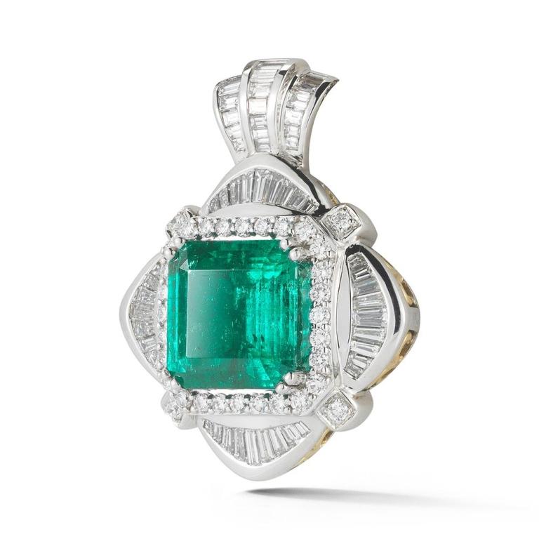 EMERALD AND DIAMOND PENDANT An exquisitely colored Colombian emerald takes center stage in this remarkable pendant. Item: # 02718 Metal: 18k W Lab: Agl Color Weight: 6.80 ct. Diamond Weight: 2.52 c
