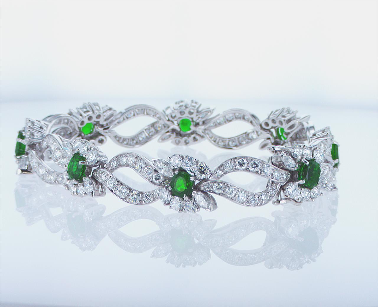 Platinum Bracelet featuring 3.37ct Total Weight of Emeralds, 6.74ct Total Weight of Round Diamonds, and 1.48ct Total Weight of Marquis Diamonds. 6.75-inch Length.
