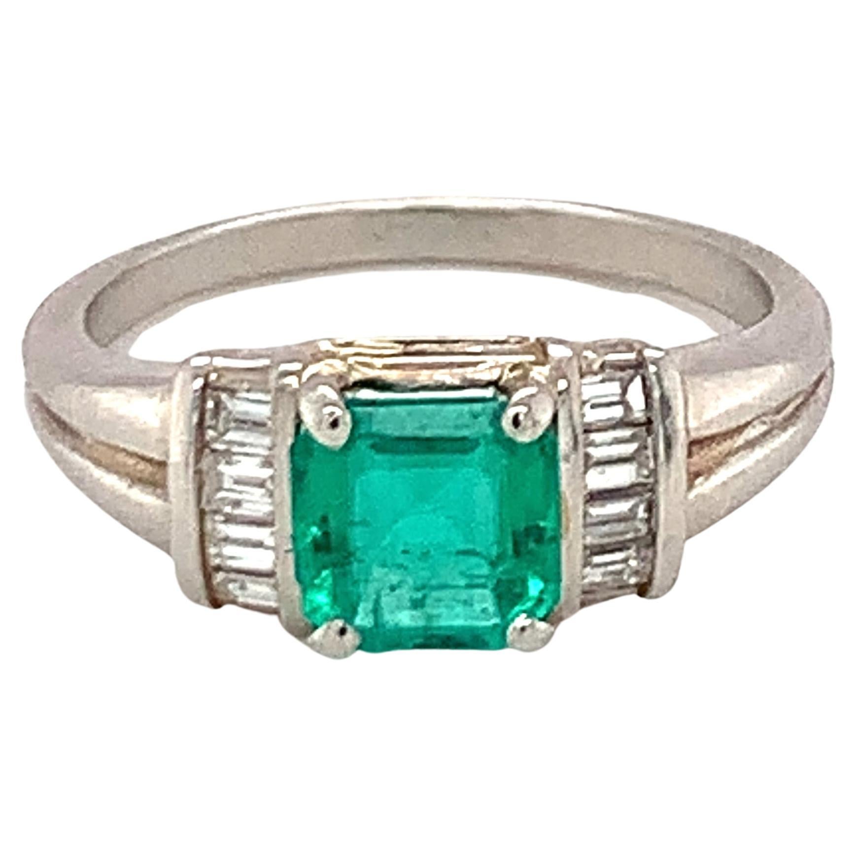 One emerald and diamond platinum ring featuring one square step-cut emerald weighing 1 ct. flanked by 8 baguette cut diamonds totaling 0.25 ct. with G color and VS-1 clarity. Contemporary piece.

Enchanting, darling, dainty.

Metal: