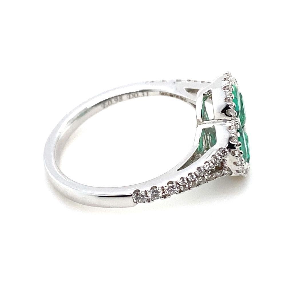 Oval Cut Emerald and Diamond Quatre Foil Cluster 18 Karat White Gold Engagement Ring For Sale