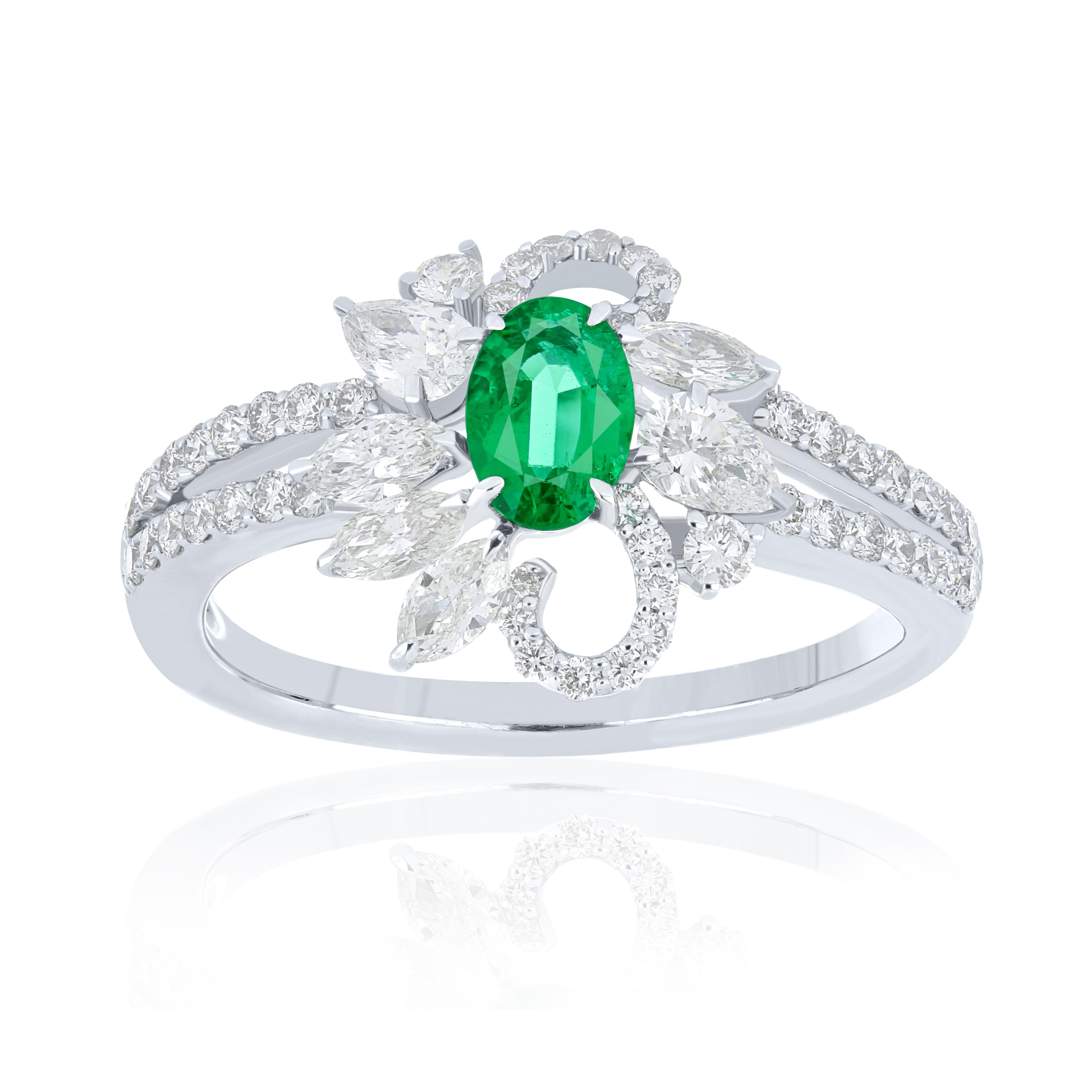Elegant and exquisitely detailed 18 Karat White Gold Ring, center set with 0.40 Cts .Oval Shape Emerald and micro pave set Diamonds, weighing approx. 0.91 Cts Beautifully Hand crafted in 18 Karat White Gold.

Stone Detail:
Emerald: 6x4MM

Stone